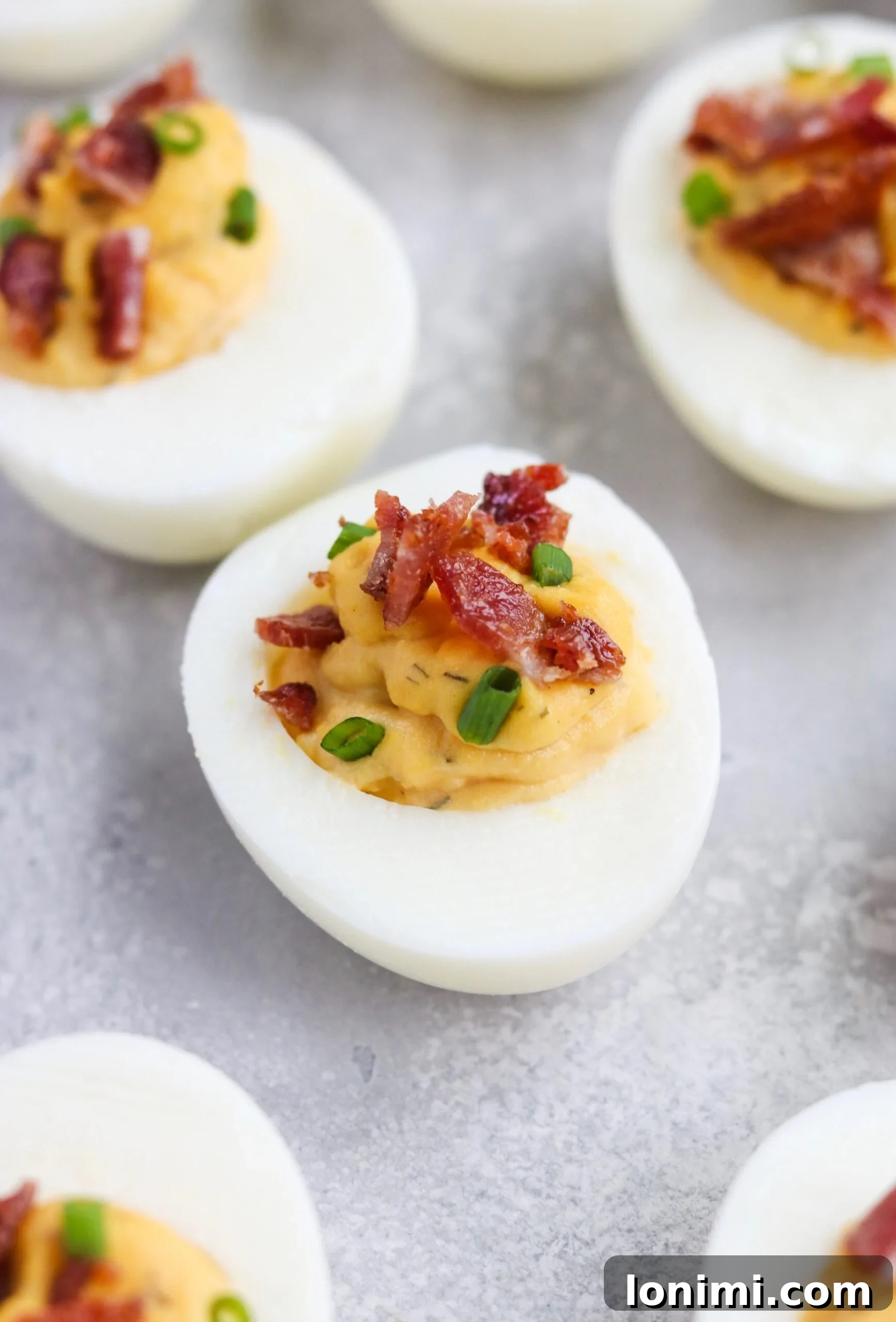 Elevated Whole30 Bacon Ranch Deviled Eggs 6 Finished Whole30 Bacon Ranch Deviled Eggs garnished with bacon and chives