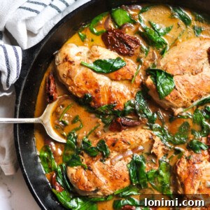 A dish of Creamy Tuscan Chicken Skillet, ready to be served