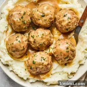 Swedish meatballs in a bowl with gravy topped with parsley