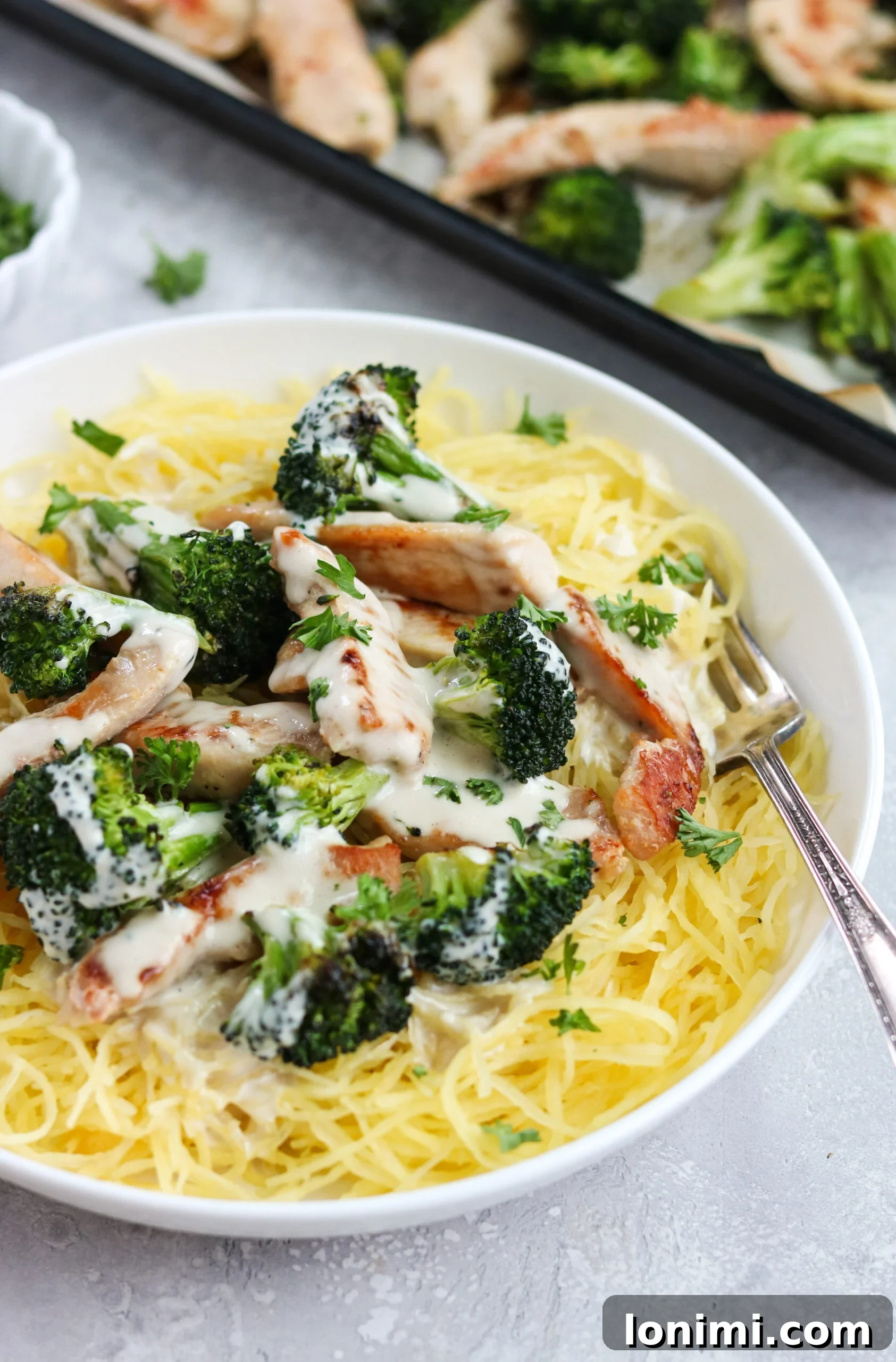 Close-up of Whole30 Chicken Broccoli Alfredo with sauce