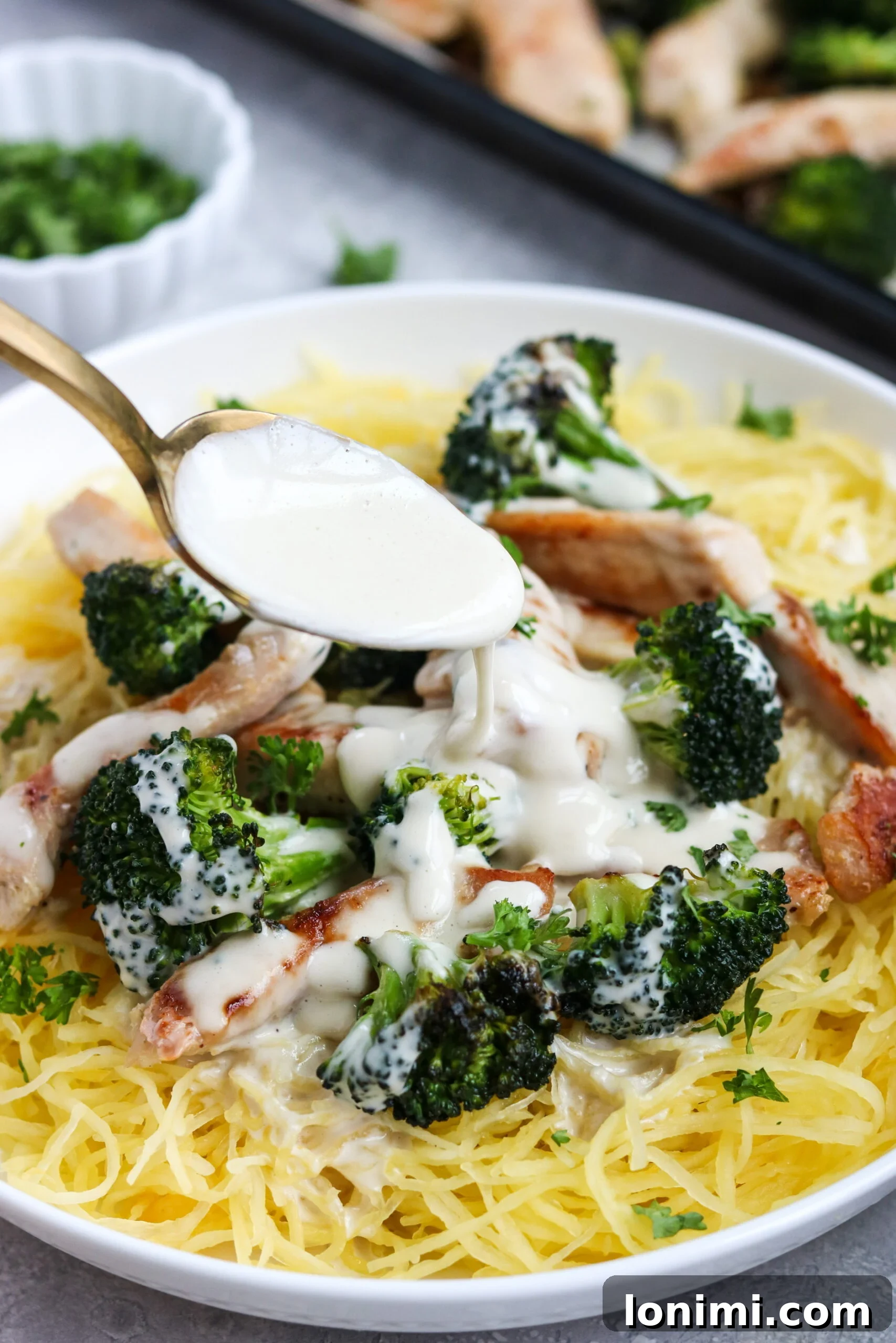 Plated Whole30 Chicken Broccoli Alfredo with herbs