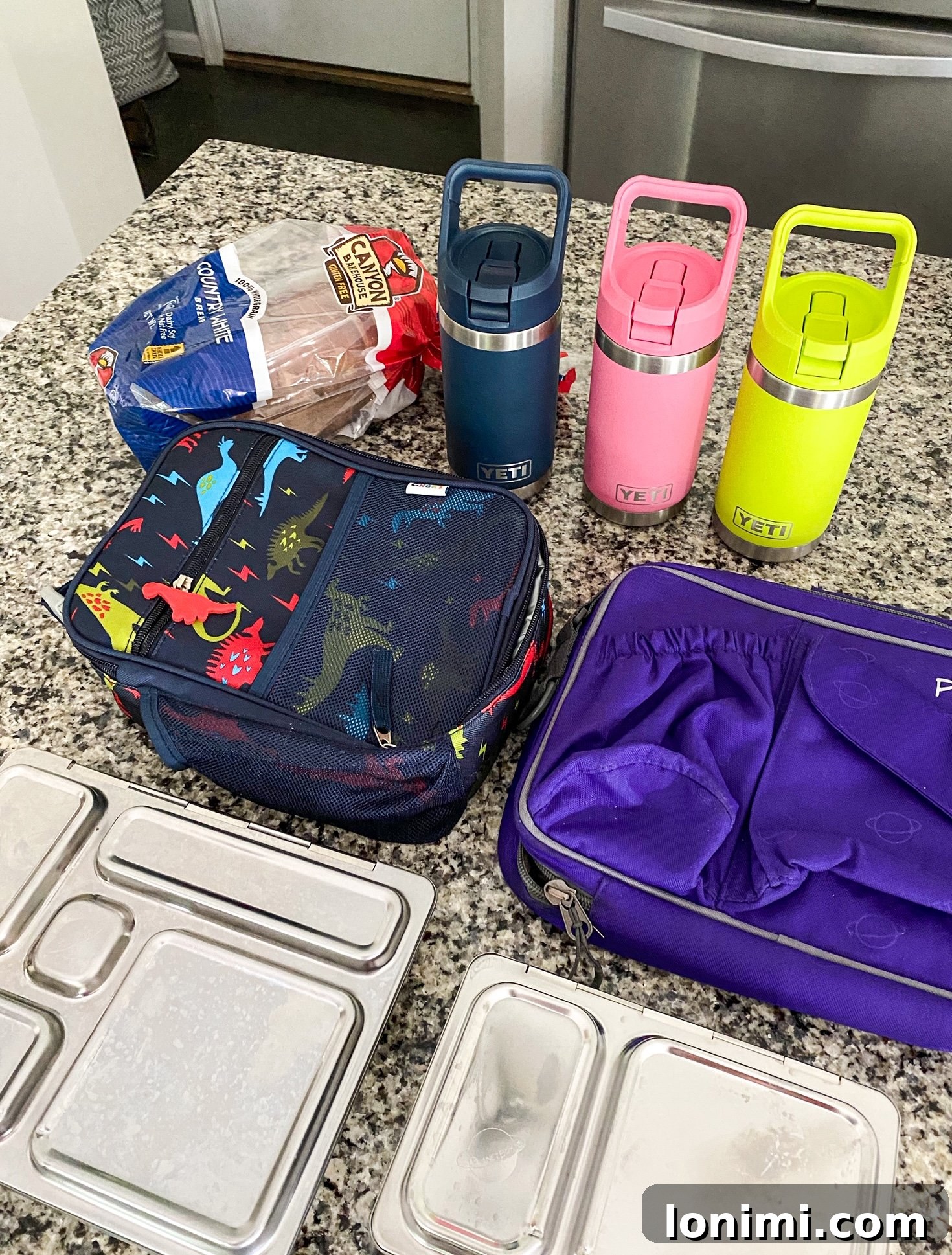 Maximize Your Time: Back-to-School Efficiency Secrets 4 Prepped school lunches in containers, including fruits, vegetables, and sandwiches, ready for the fridge