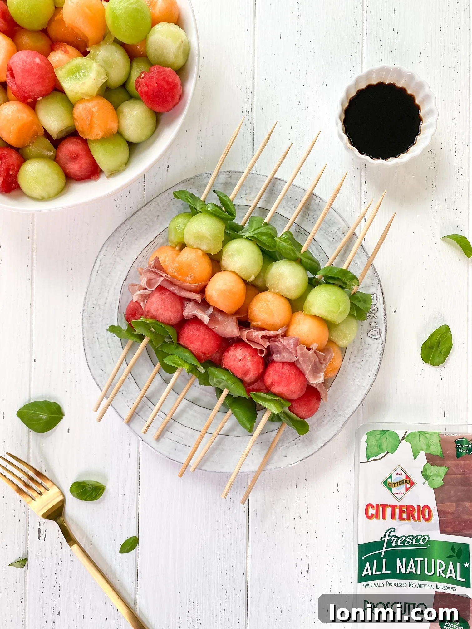 Assorted Whole30 Melon Basil Prosciutto Skewers on a serving platter