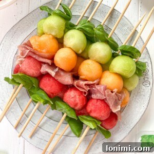 Melon Basil Prosciutto Skewers arranged beautifully on a plate