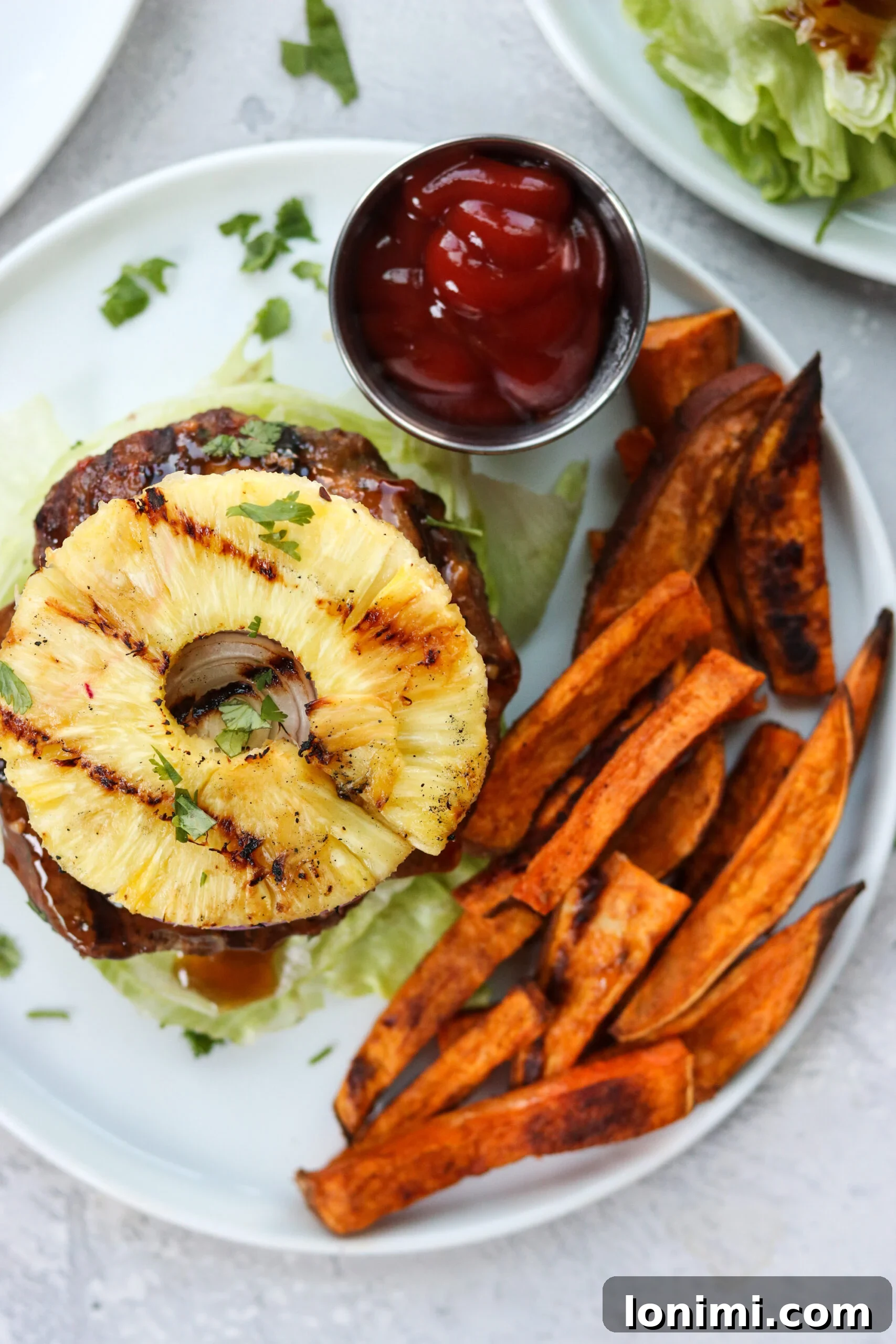 Tropical Teriyaki Whole30 Burgers with Grilled Pineapple 6 Finished Whole30 Teriyaki Burgers with Grilled Pineapple served on a platter