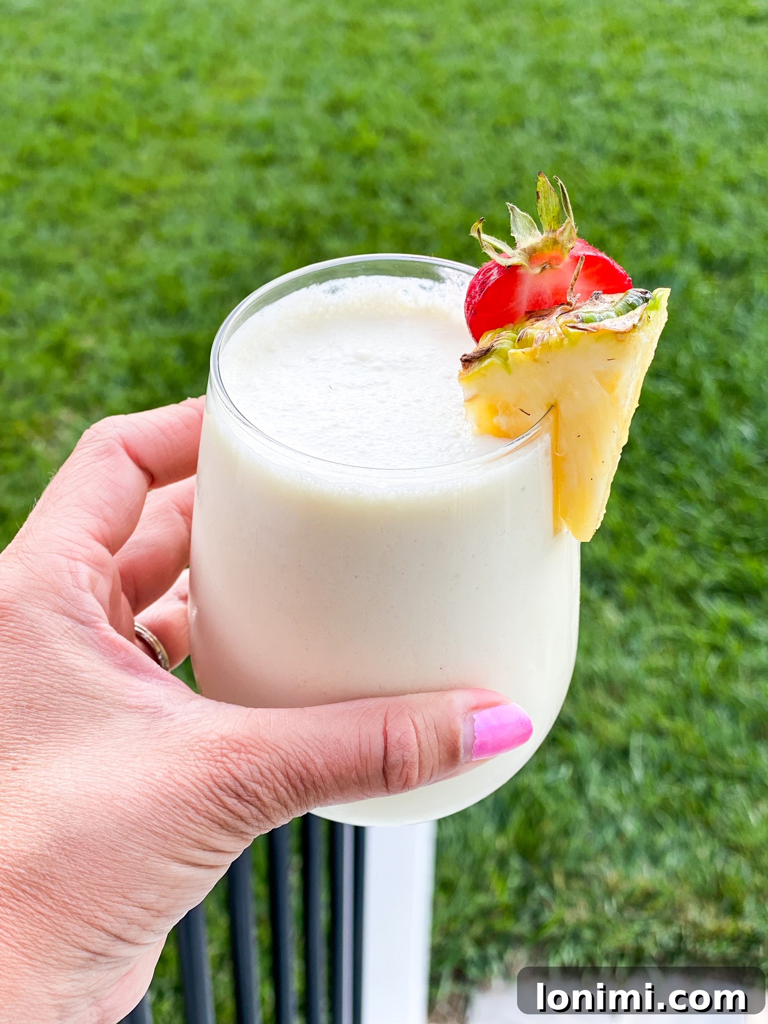 Creamy Paleo Pina Colada 2 Paleo Pina Colada in a glass with pineapple and mint garnish
