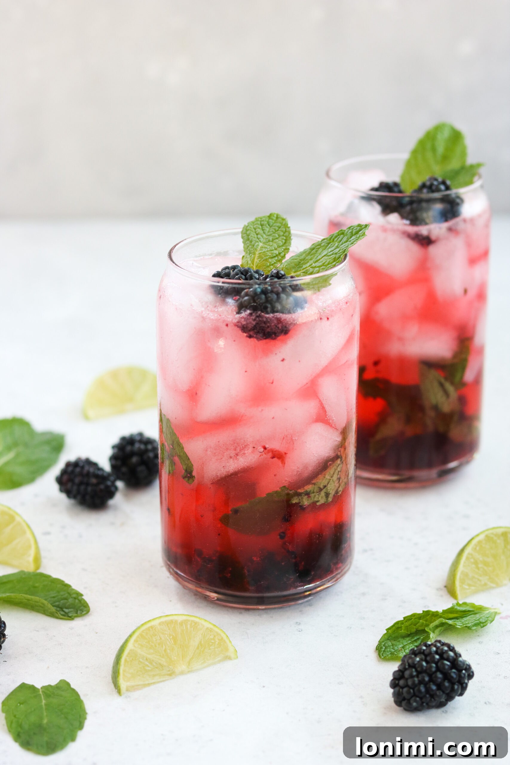 Close-up of a Paleo Blackberry Mojito cocktail with fresh berries and mint garnish