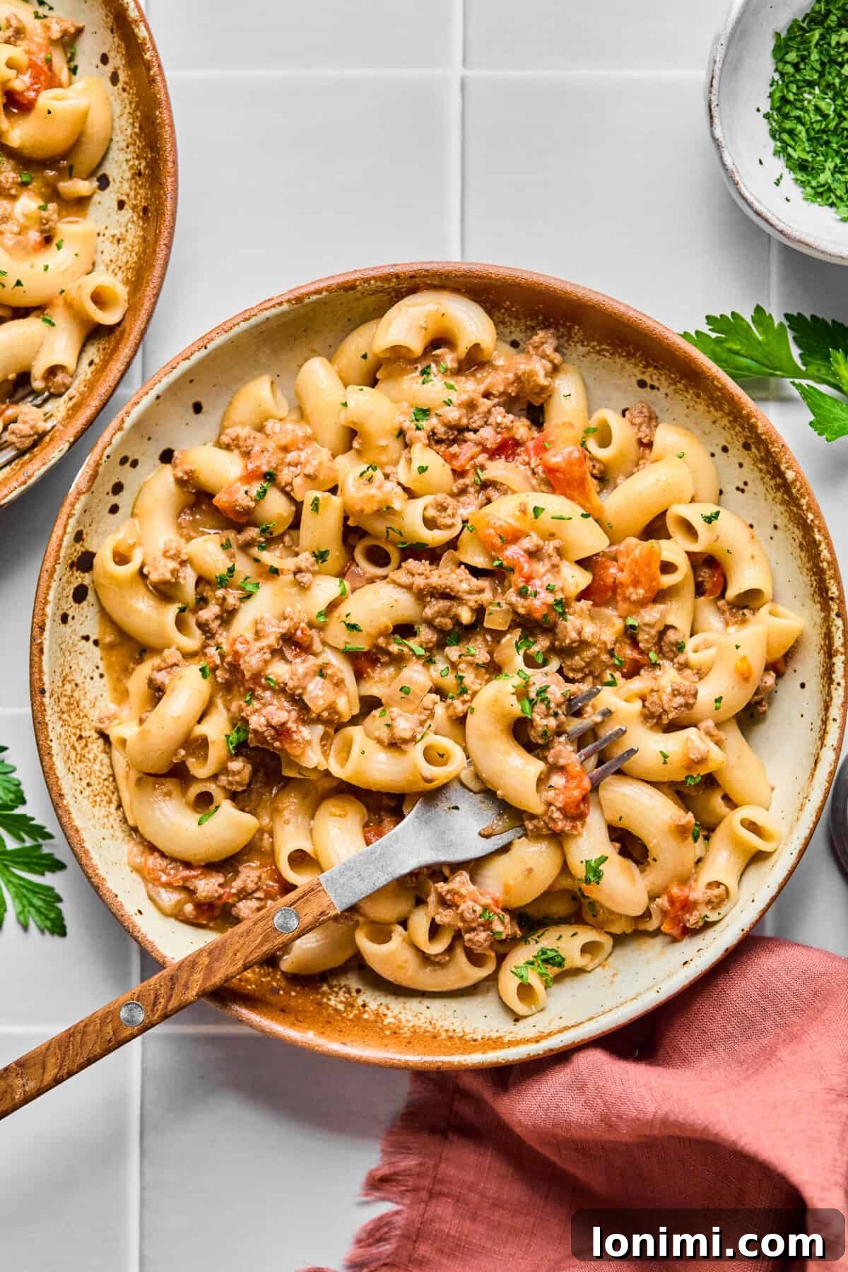 Hearty Gluten-Free Beef and Pasta Skillet Dairy-Free Option 2 A serving of homemade gluten-free hamburger helper in a bowl with a fork, ready to eat.