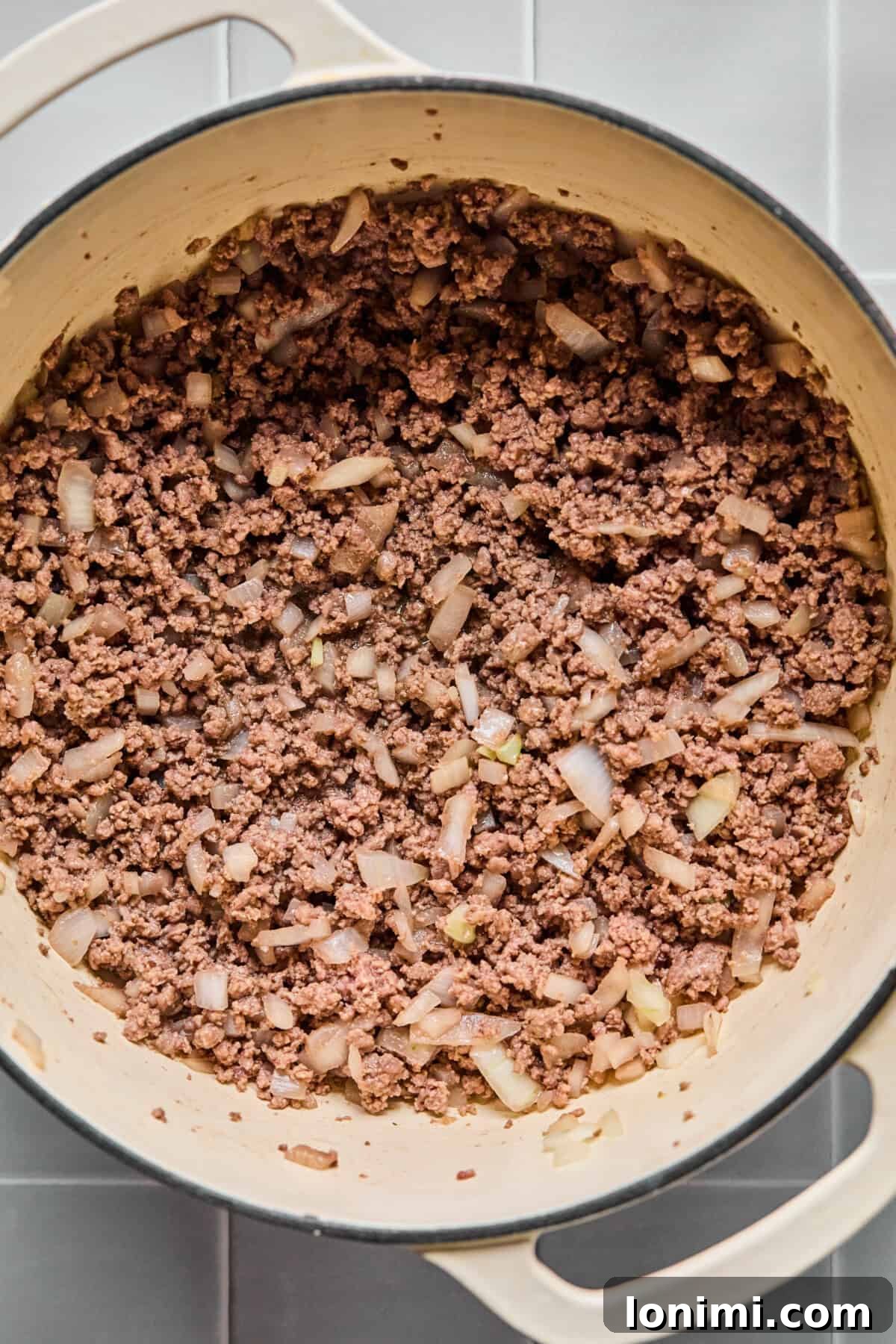 Hearty Gluten-Free Beef and Pasta Skillet Dairy-Free Option 4 Ground beef, diced onions, and minced garlic sautéing in a large skillet, beginning to brown.