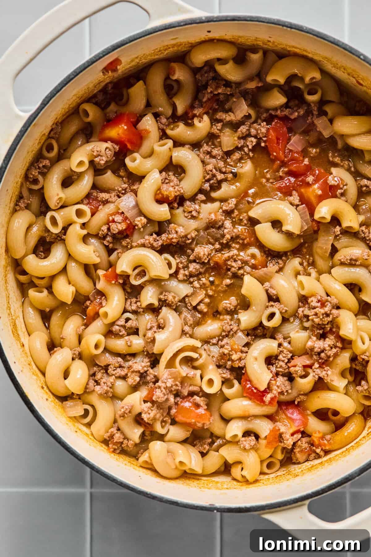 Hearty Gluten-Free Beef and Pasta Skillet Dairy-Free Option 7 The gluten-free pasta, beef, and tomato mixture simmering in the pot, with most of the liquid absorbed and the sauce thickening.