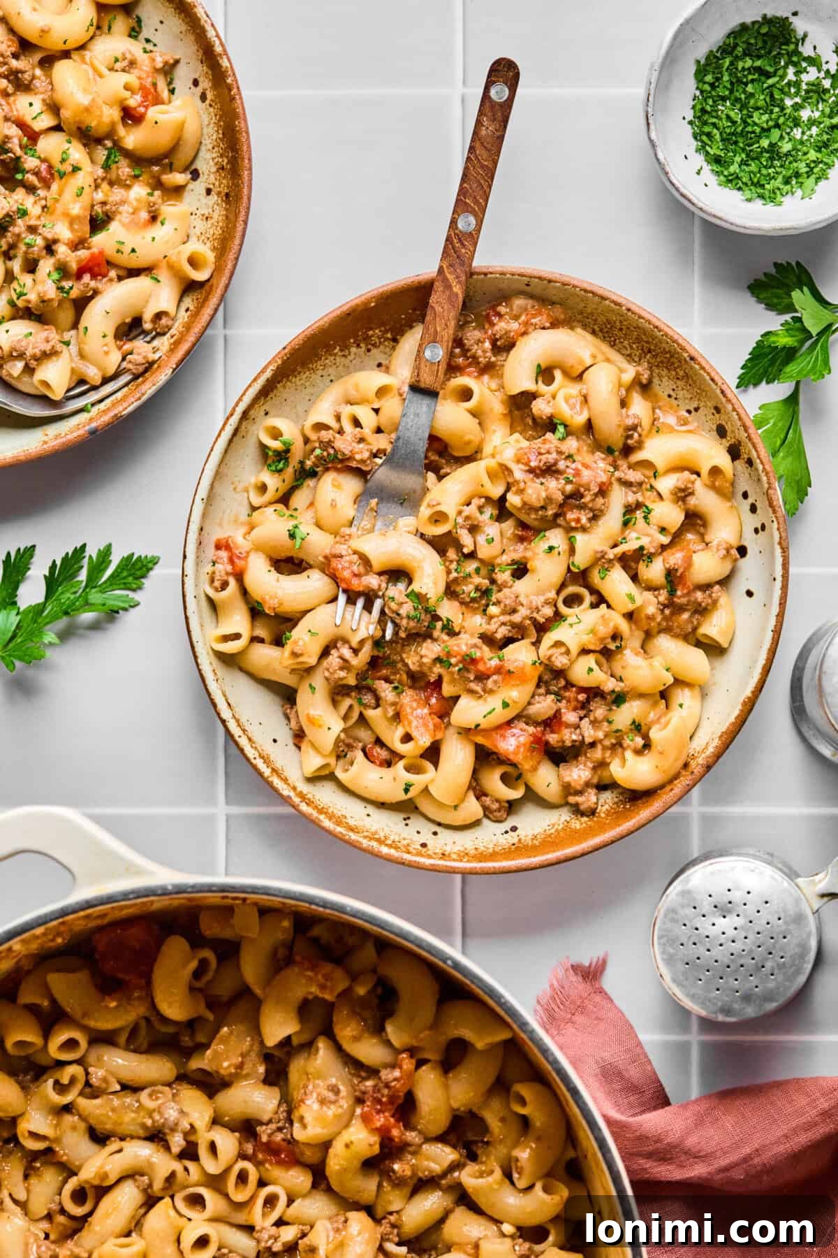 Hearty Gluten-Free Beef and Pasta Skillet Dairy-Free Option 10 Two bowls filled with hearty gluten-free hamburger helper, garnished with fresh parsley.