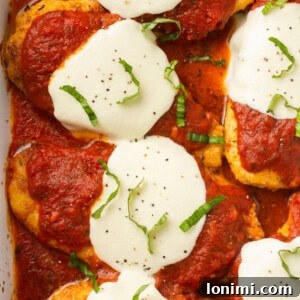 gluten free chicken parmesan in a casserole dish topped with basil