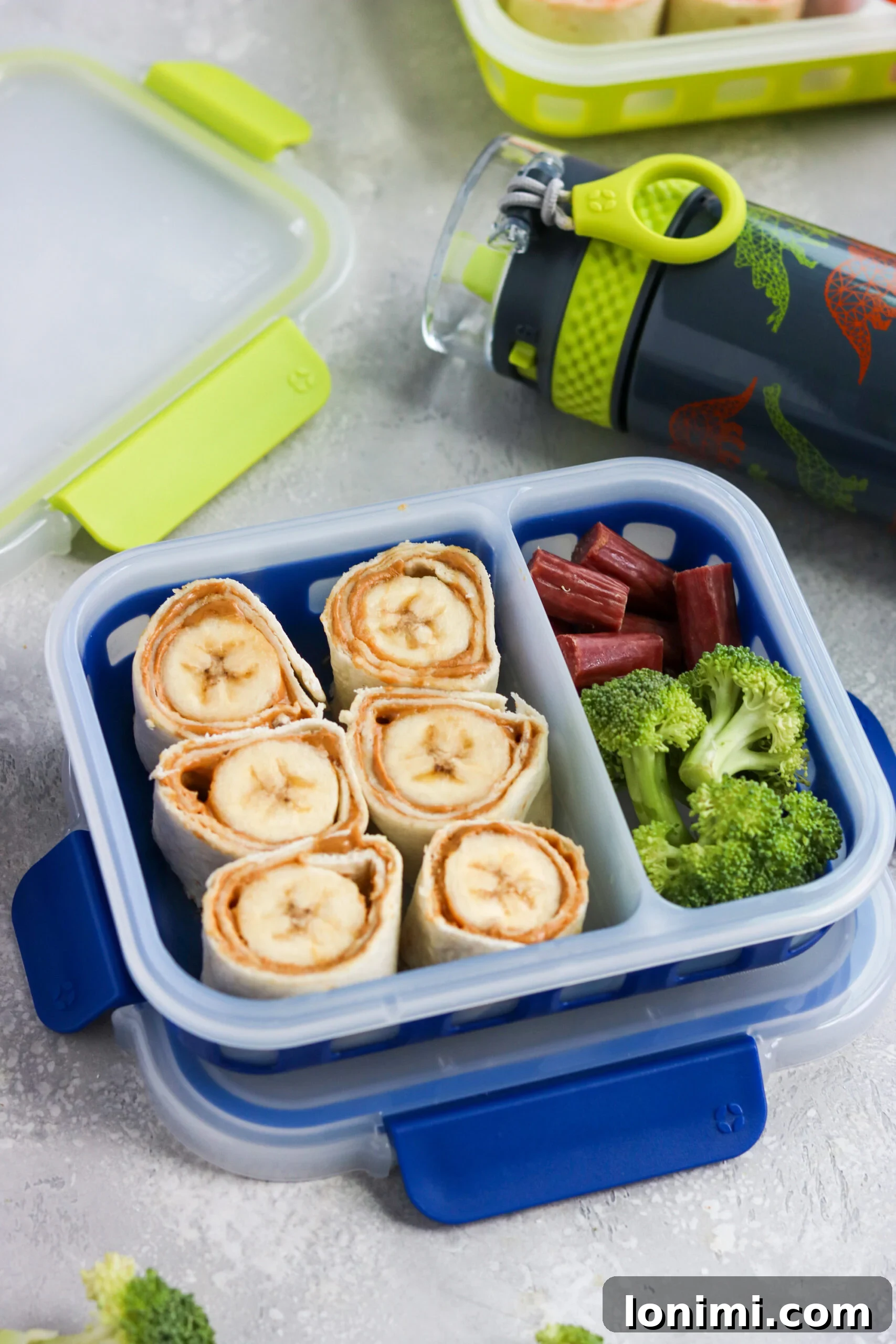 Close-up of freshly made Banana Peanut Butter Honey Pinwheels in a lunchbox
