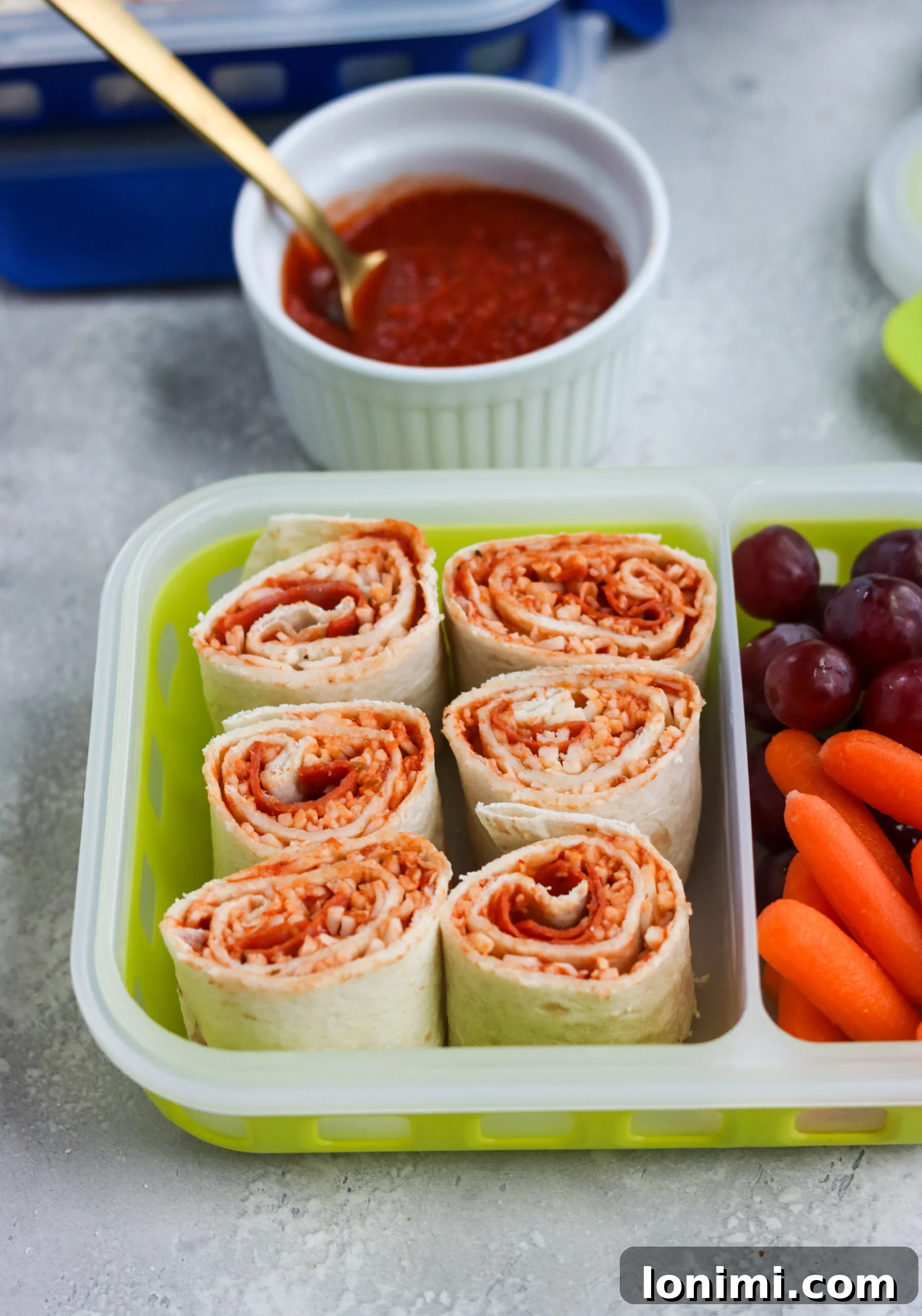 Freshly prepared Pizza Pinwheels in a bento-style lunchbox