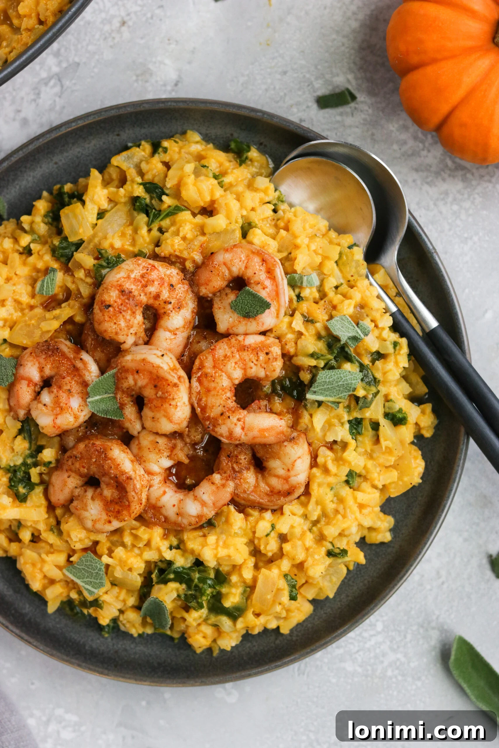 Close-up of creamy Whole30 Pumpkin Risotto with succulent shrimp and a sprinkle of fresh parsley