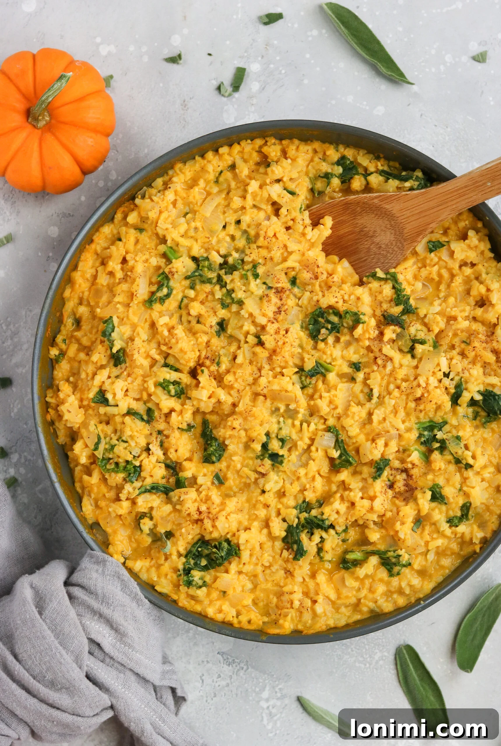 A beautifully plated dish of Whole30 Pumpkin Risotto, garnished with fresh herbs and plump shrimp