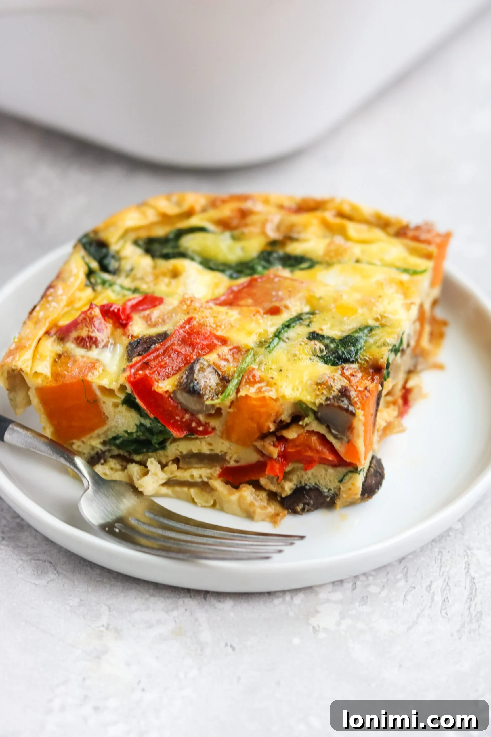 A slice of the perfectly baked Roasted Veggie Breakfast Casserole