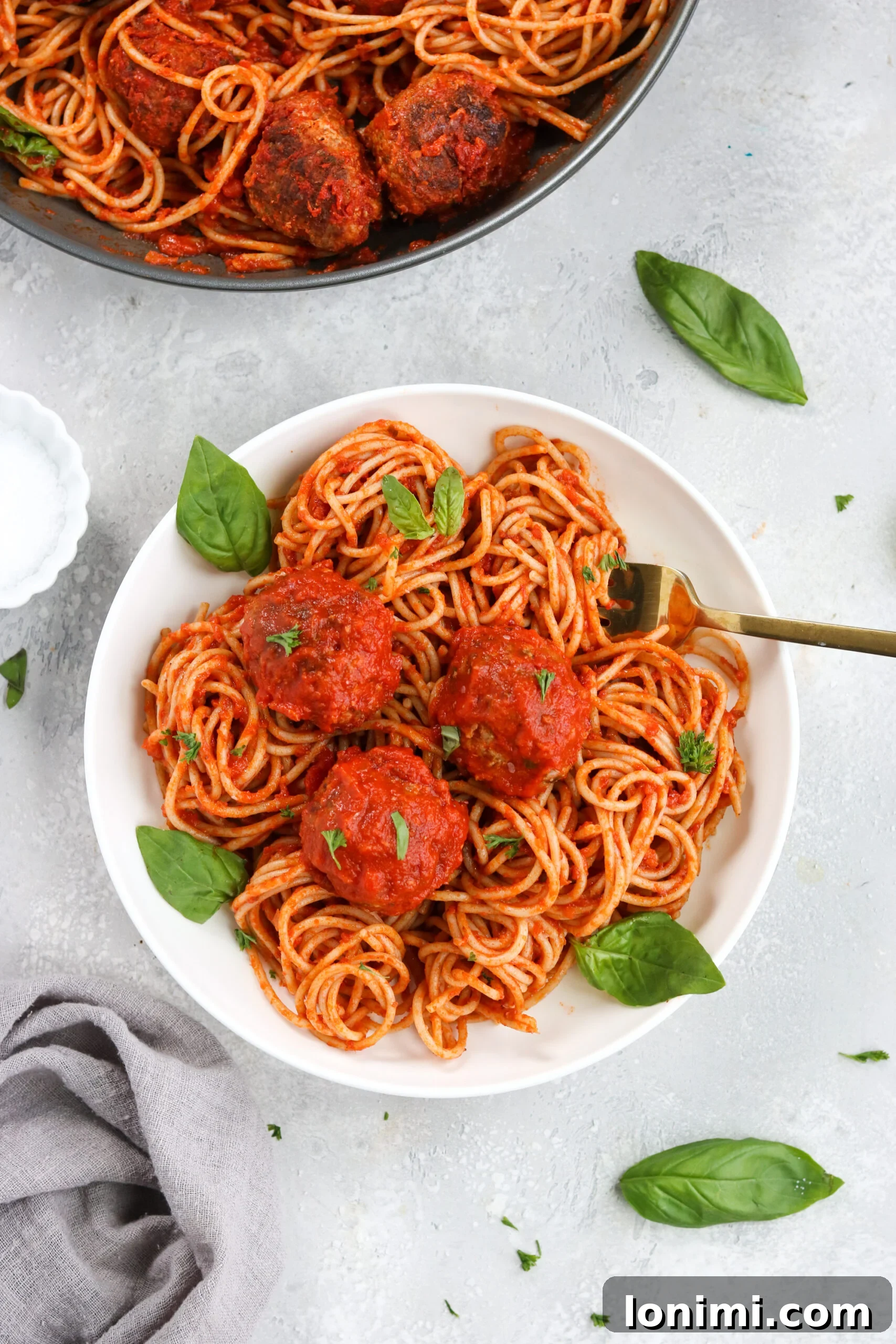 Platter of Gluten-Free Italian Meatballs with Homemade Marinara, garnished with fresh basil, ready to be served.