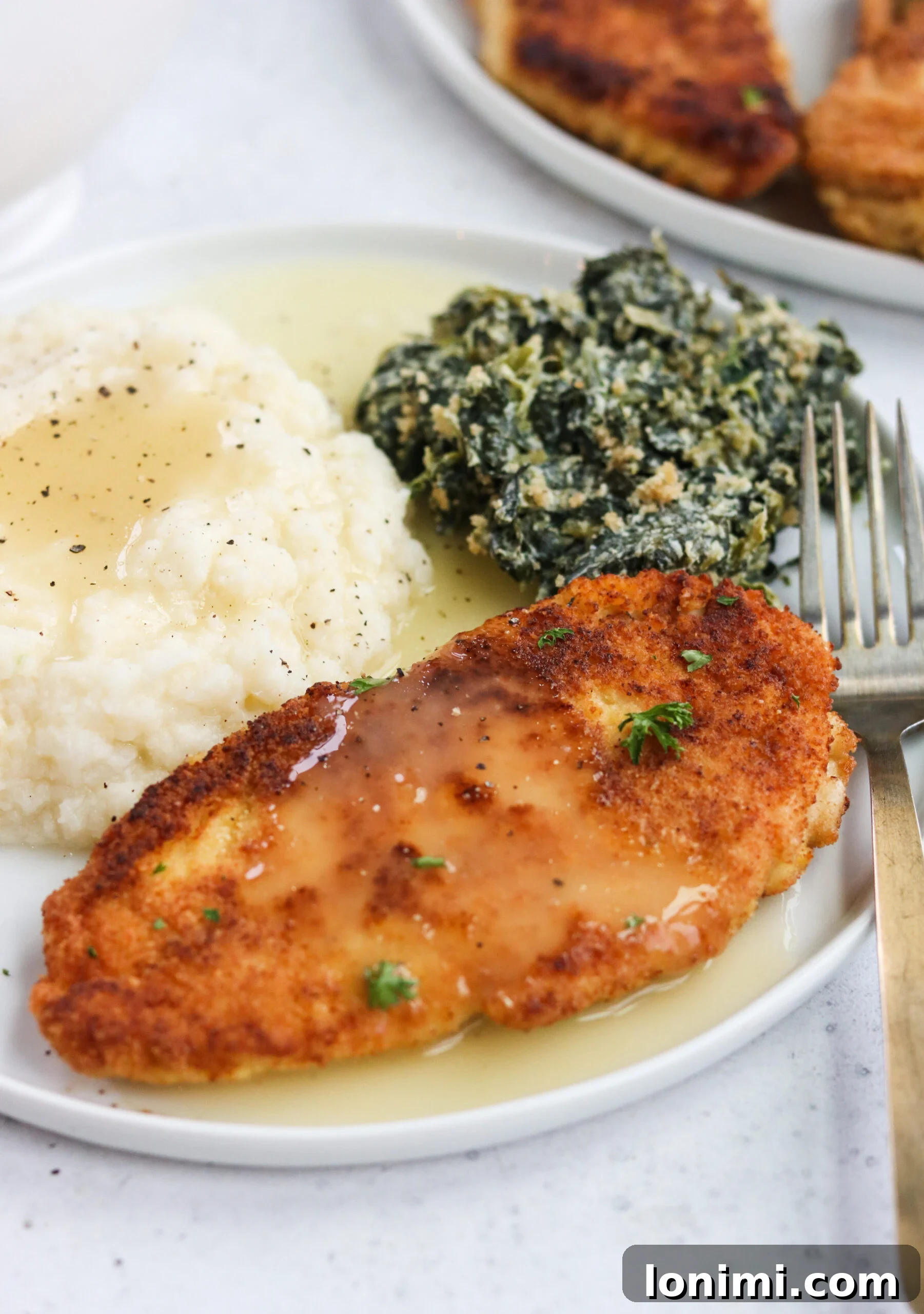 A close-up of three crispy Whole30 Fried Chicken Cutlets, golden and perfectly seasoned.