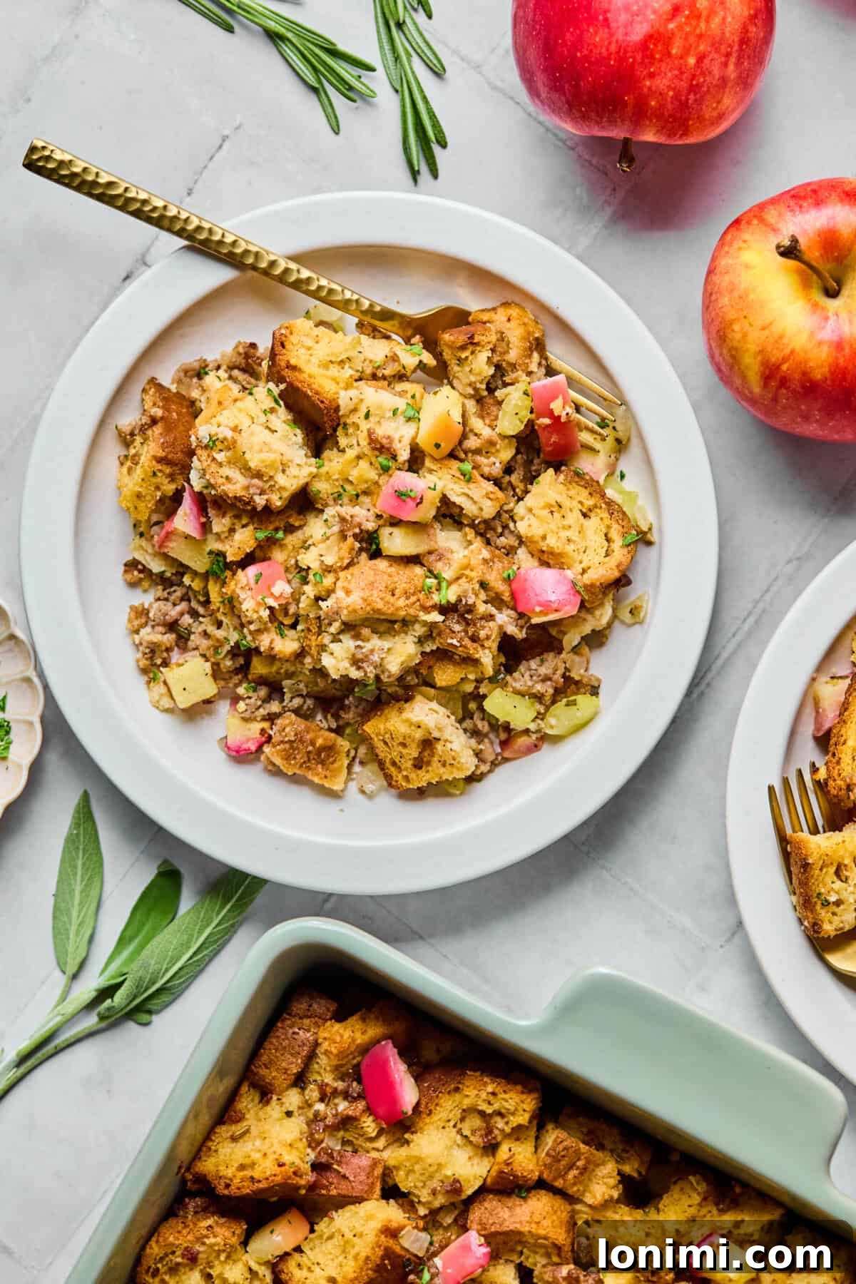 gluten free stuffing on a plate with a casserole dish near by and apples surrounding it