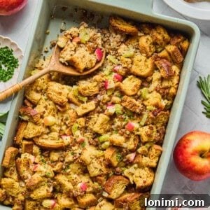 sausage apple herb stuffing in a blue casserole dish