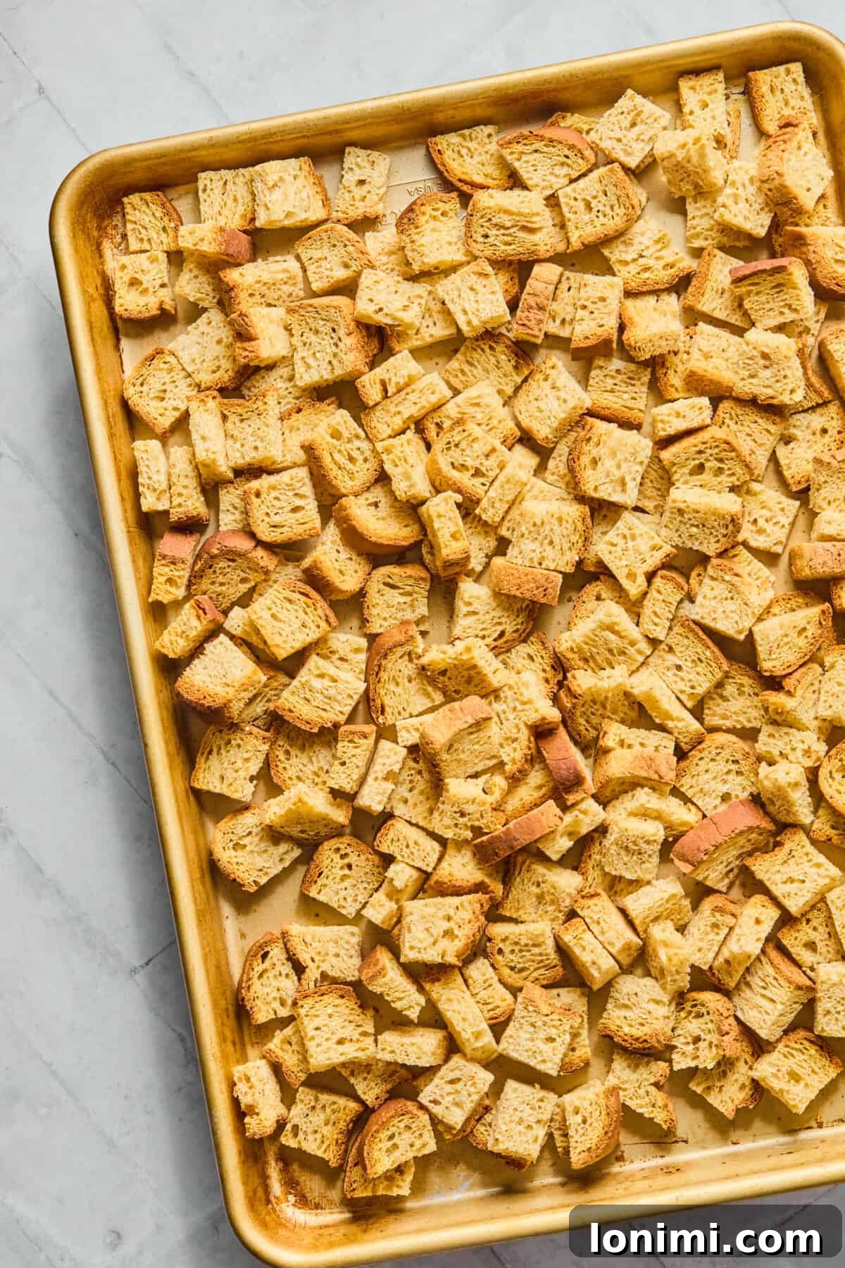 gluten free bread cubes on a baking pan