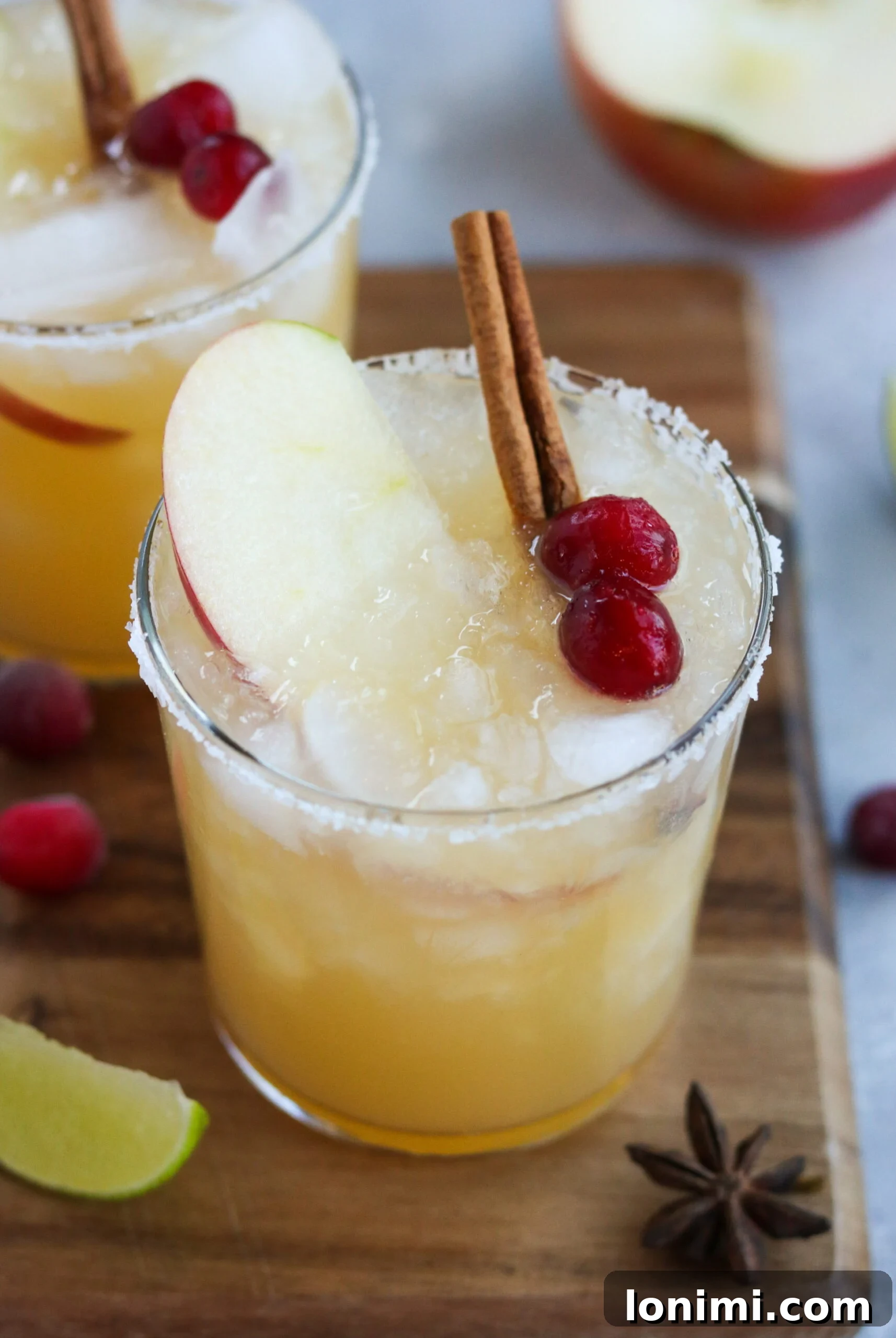 closeup of a thanksgiving cocktail filled with tequila, apple cider, and honey cinnamon simple syrup