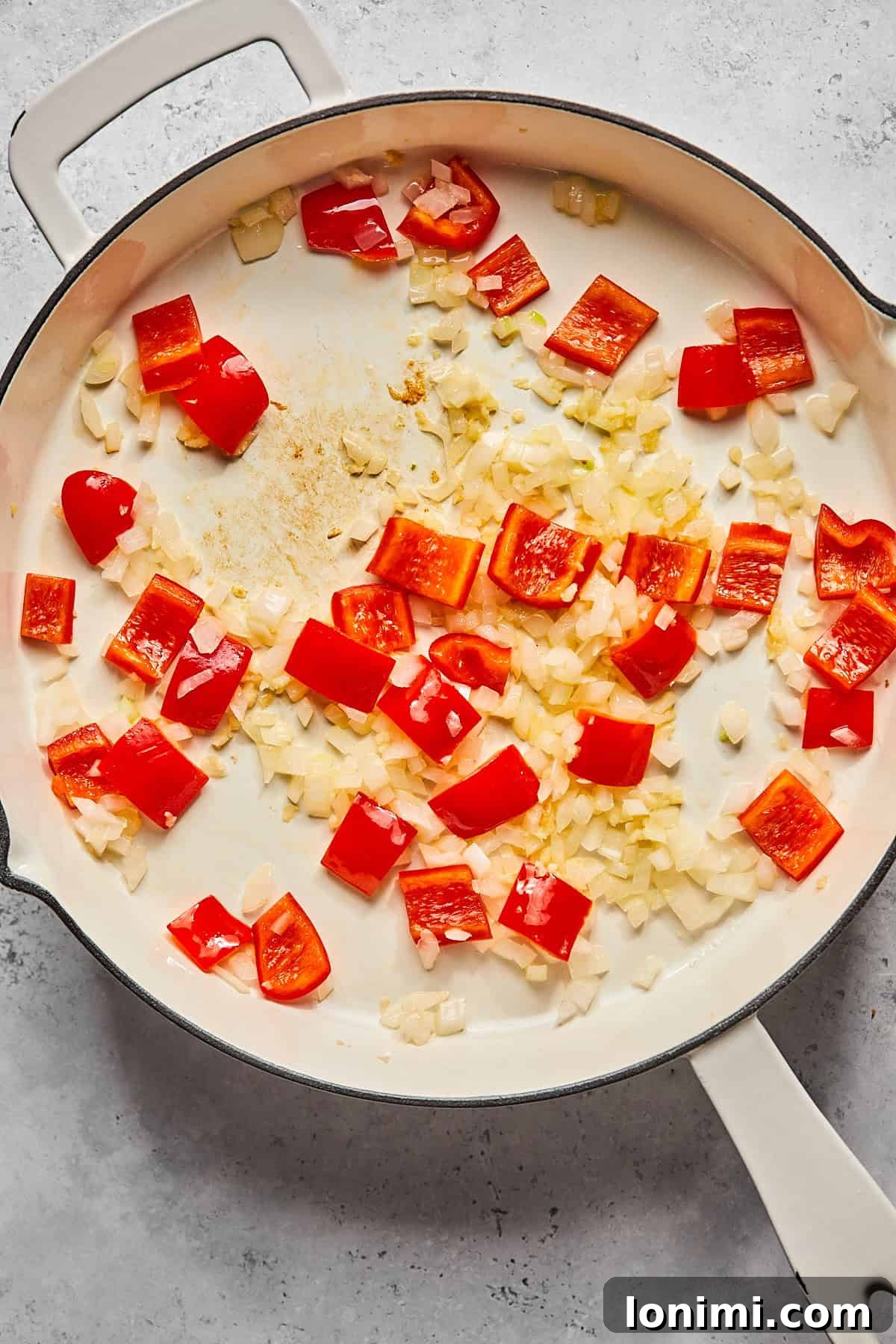 onions and peppers in a skillet 