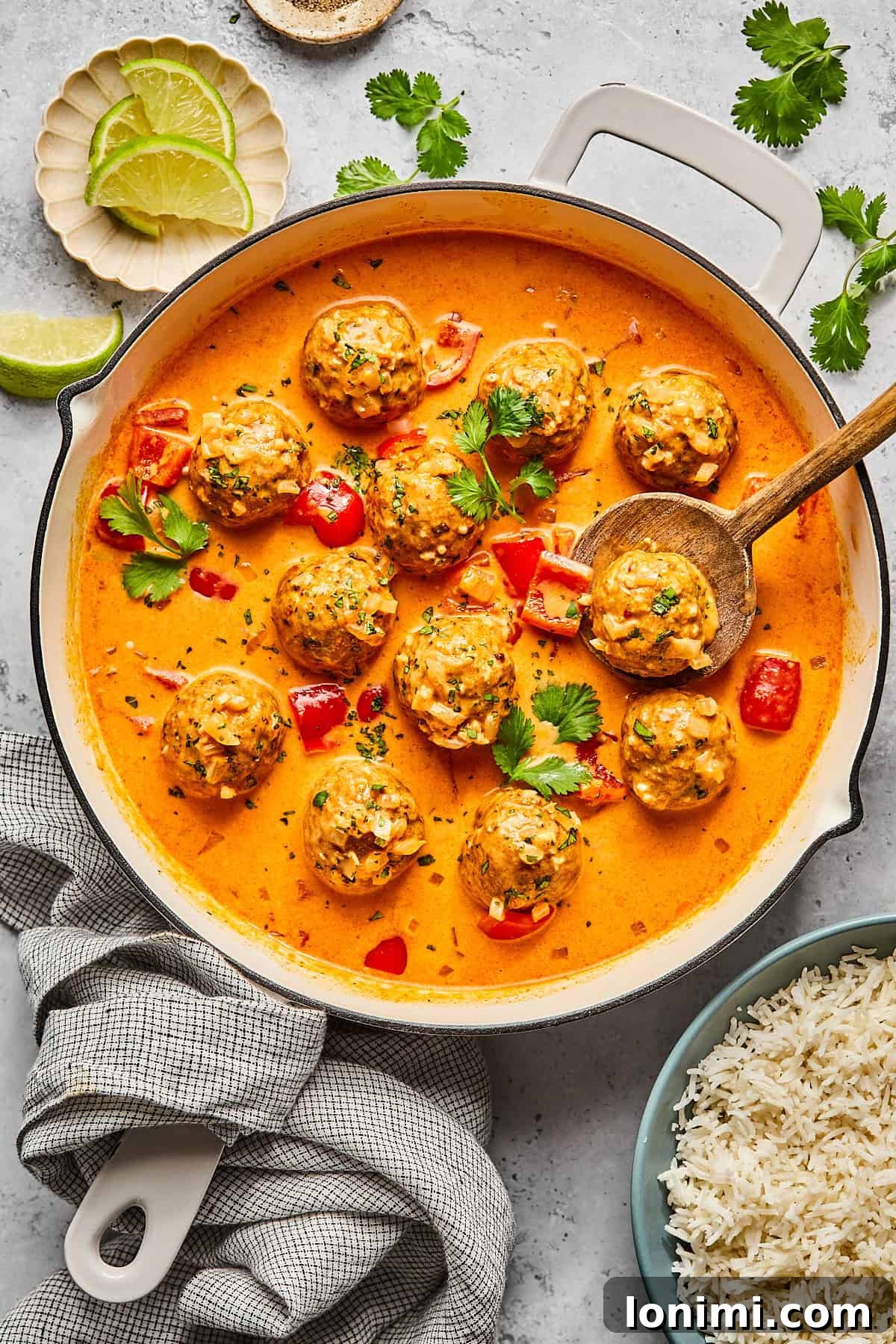 thai turkey meatballs in a skillet with sauce and cilantro on top