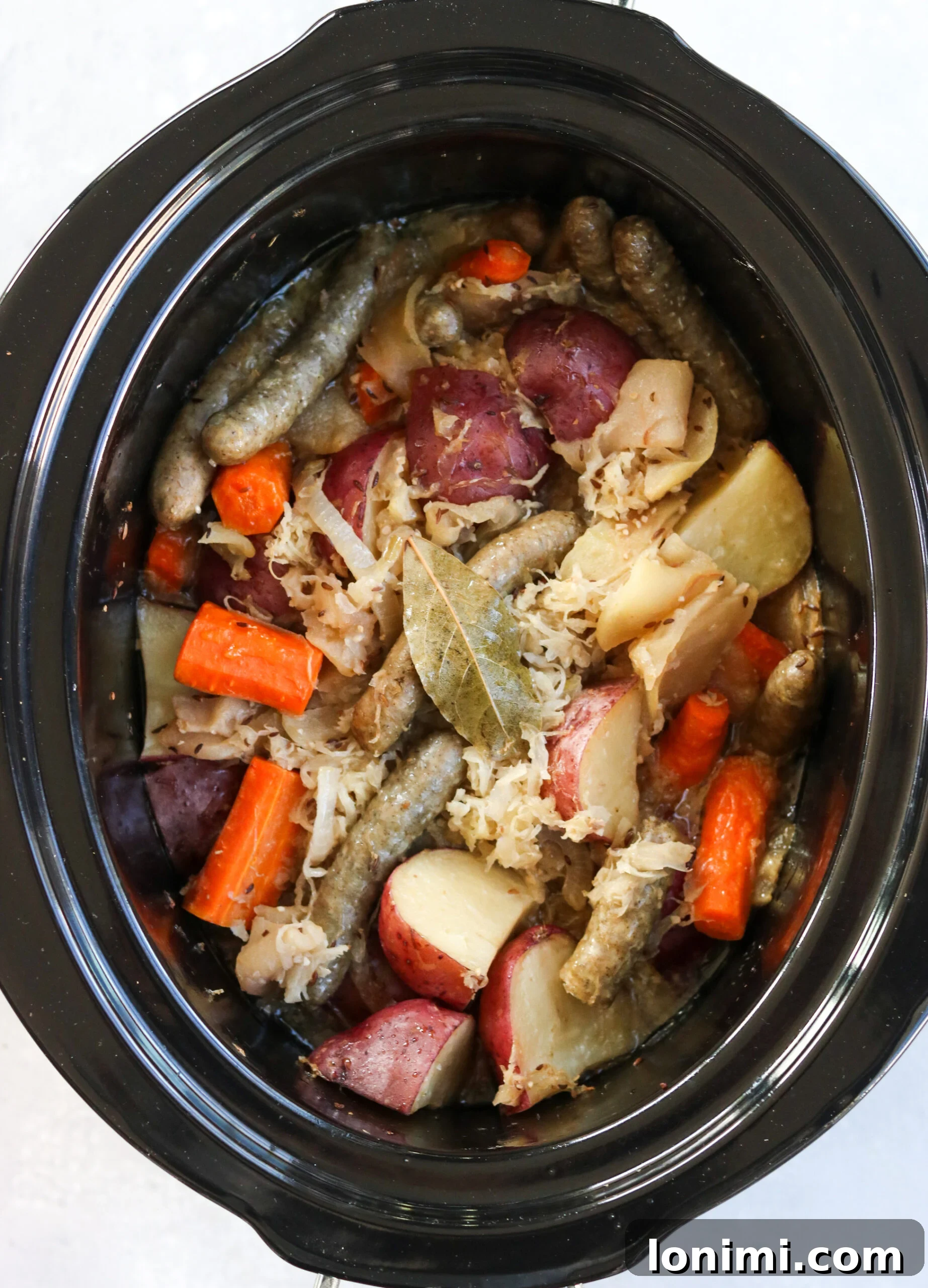 Slow Cooker Sweet and Savory Sausage with Apples and Sauerkraut 5 Close-up of raw Jones Dairy Farm sausages, ready for cooking.