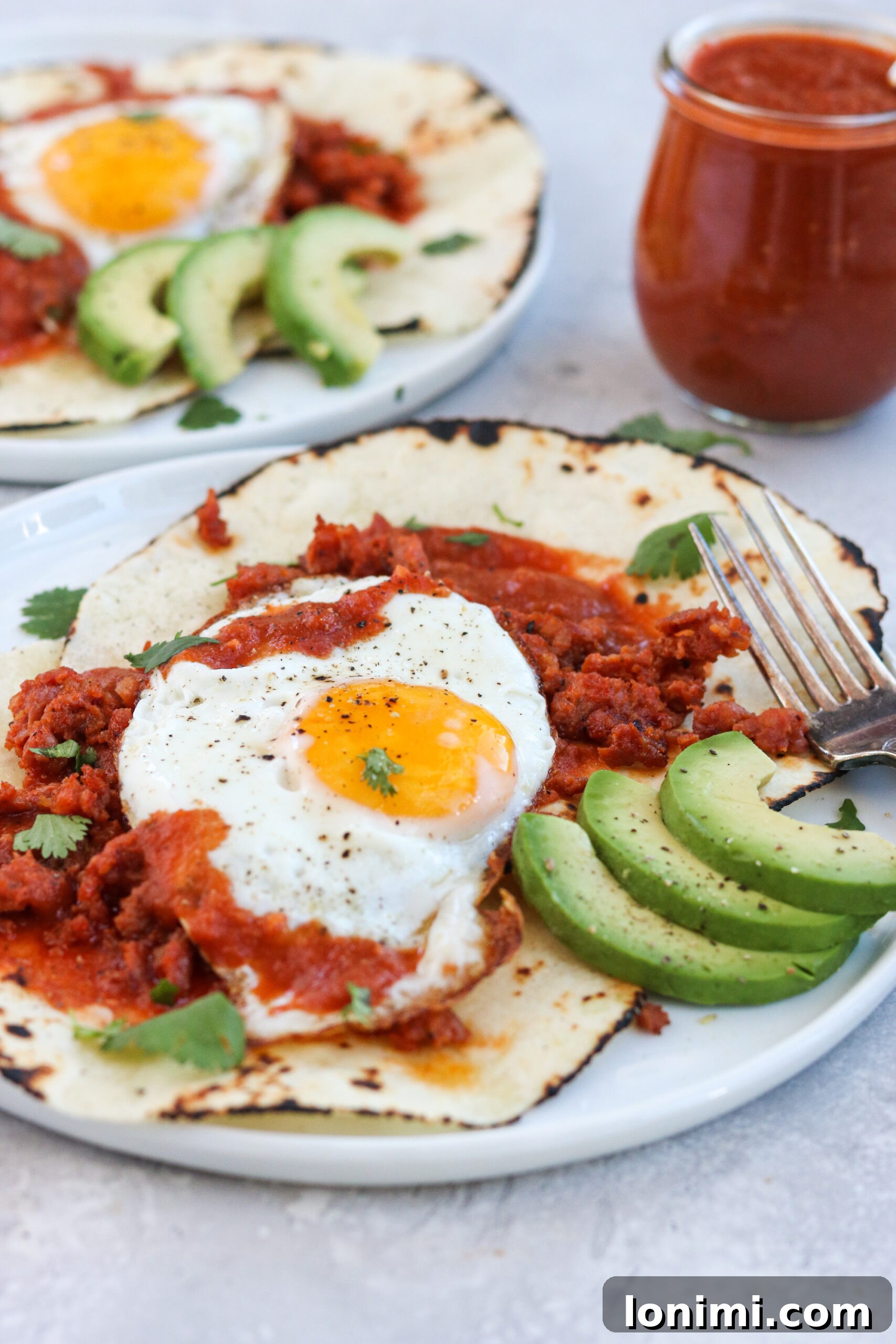 Delicious Paleo Huevos Rancheros topped with creamy avocado and fresh cilantro