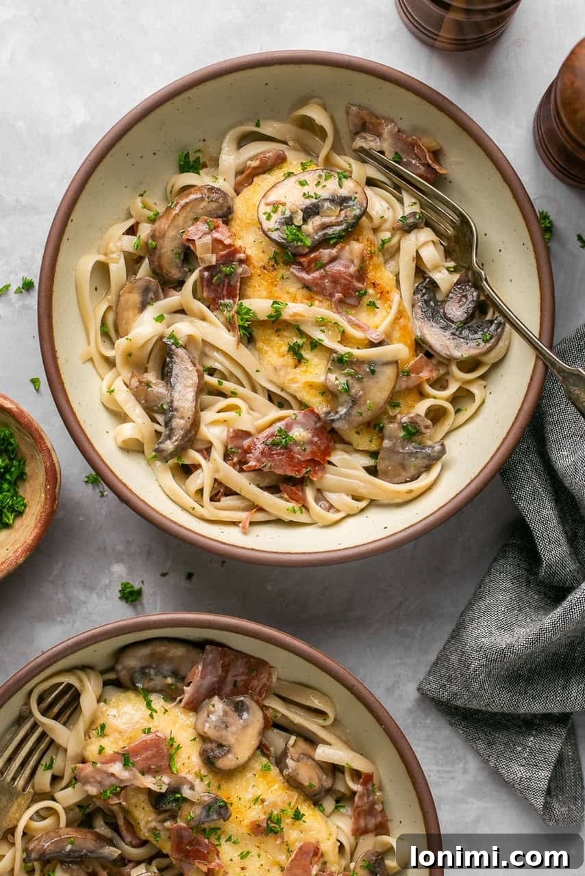 chicken marsala with pasta in 2 bowls with a gray napkin next to them