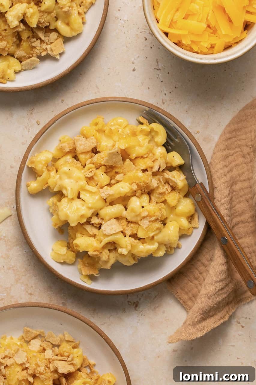No-Fuss Gluten-Free Oven-Baked Mac and Cheese Perfection 8 Plates of baked gluten free mac and cheese with a brown napkin, ready for serving.