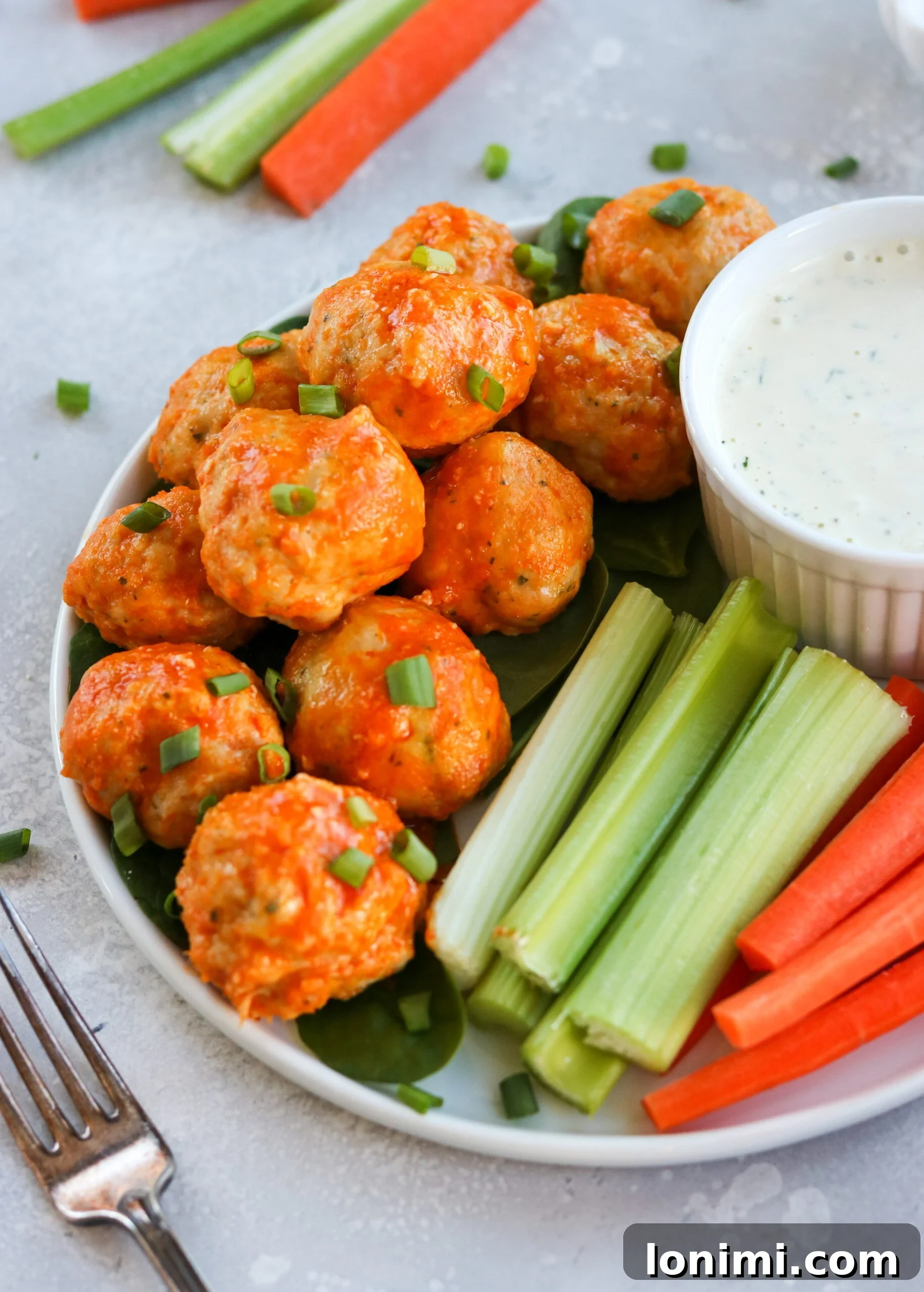 A close-up of gluten-free, dairy-free buffalo chicken meatballs, showcasing their rich color and inviting texture
