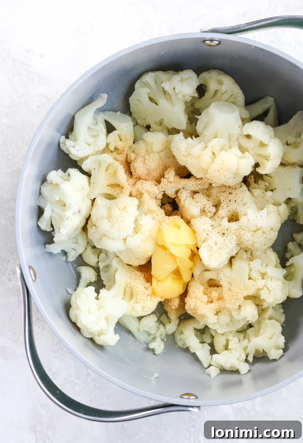 Cauliflower, ghee, broth, garlic powder, and salt in a pot