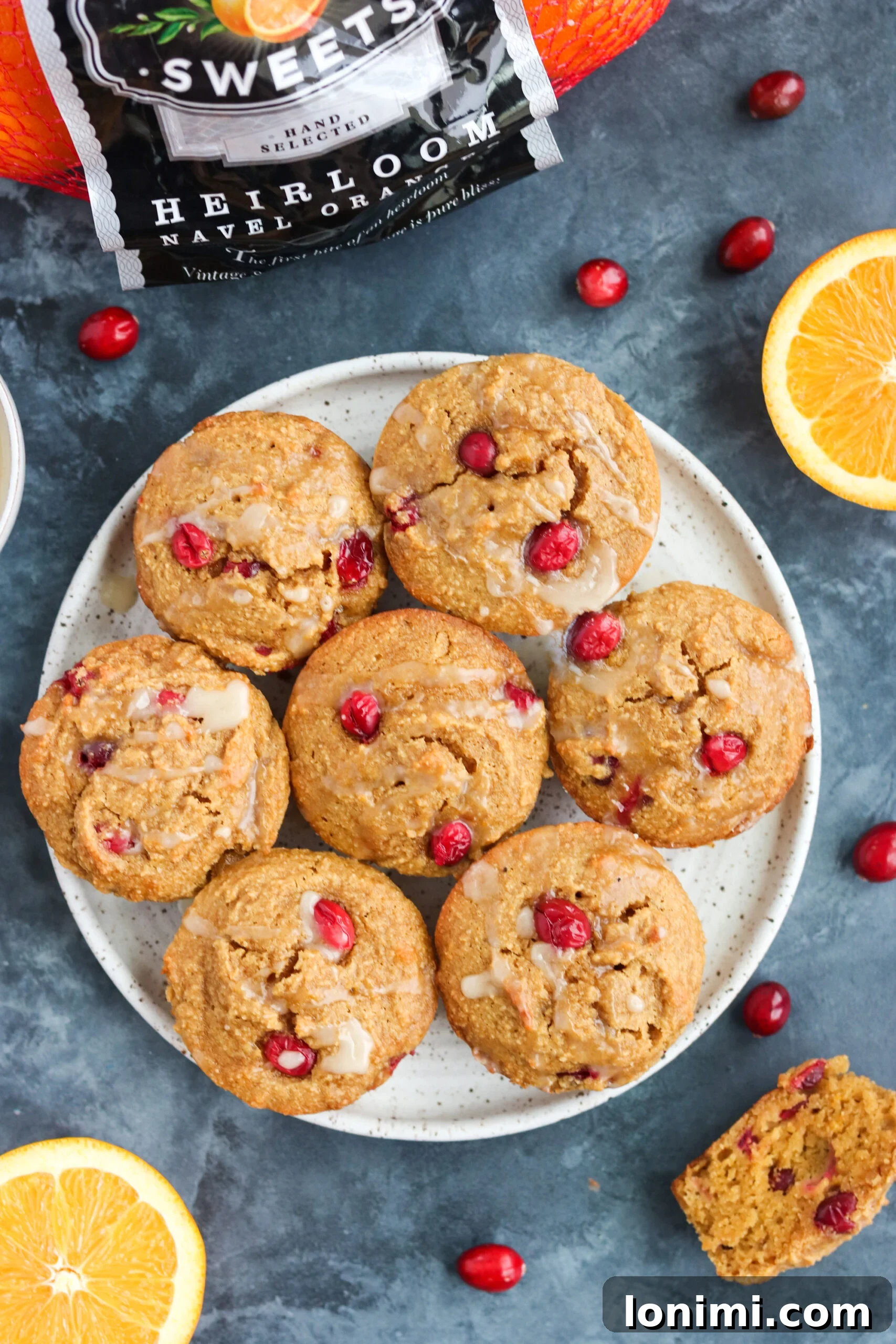 Finished Paleo Cranberry Orange Muffins An overhead view of a tray of freshly baked Paleo Orange Cranberry Muffins, perfectly golden and ready to be enjoyed, with a light dusting or drizzle.