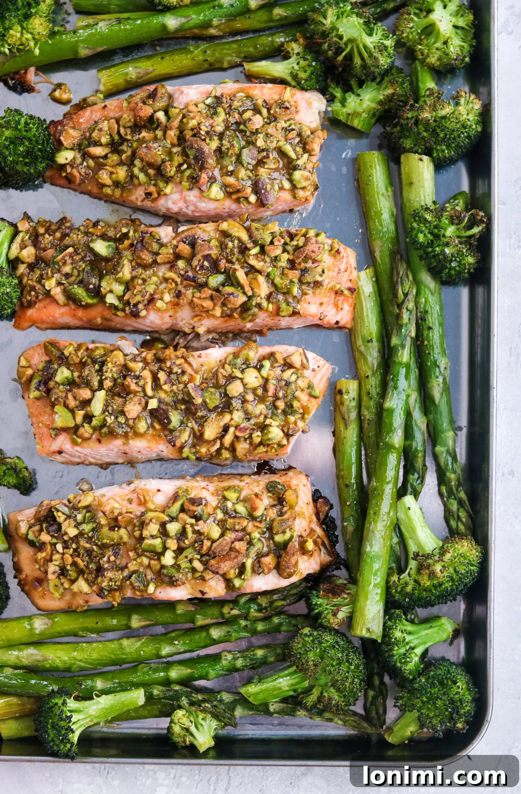 Crusted Salmon with Spring Veggies on a baking sheet Crusted Salmon with Spring Veggies on a baking sheet, showcasing a full sheet pan meal