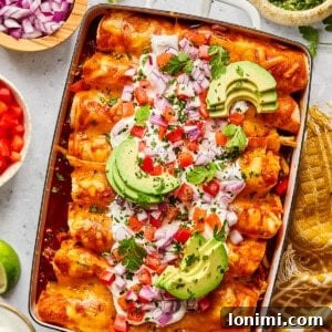 Weeknight Chicken and Black Bean Enchiladas 13 Chicken and black bean enchiladas with toppings in a casserole dish