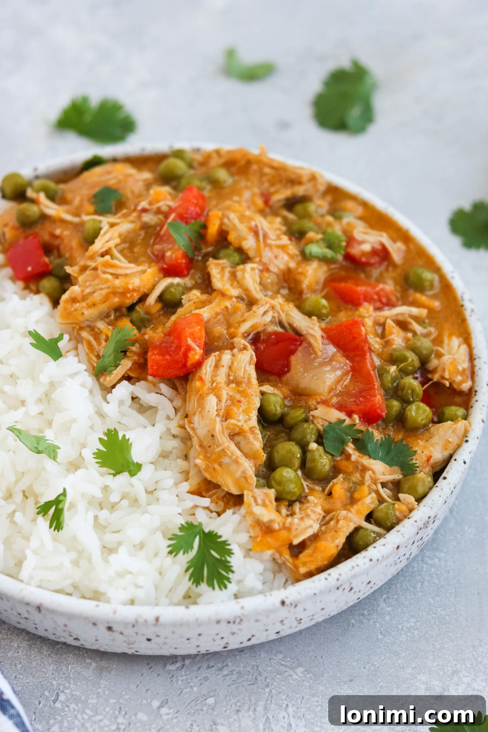 Delicious Instant Pot Chicken and Sweet Potato Curry A vibrant plate of Instant Pot Chicken and Sweet Potato Curry served over rice, garnished with fresh cilantro.