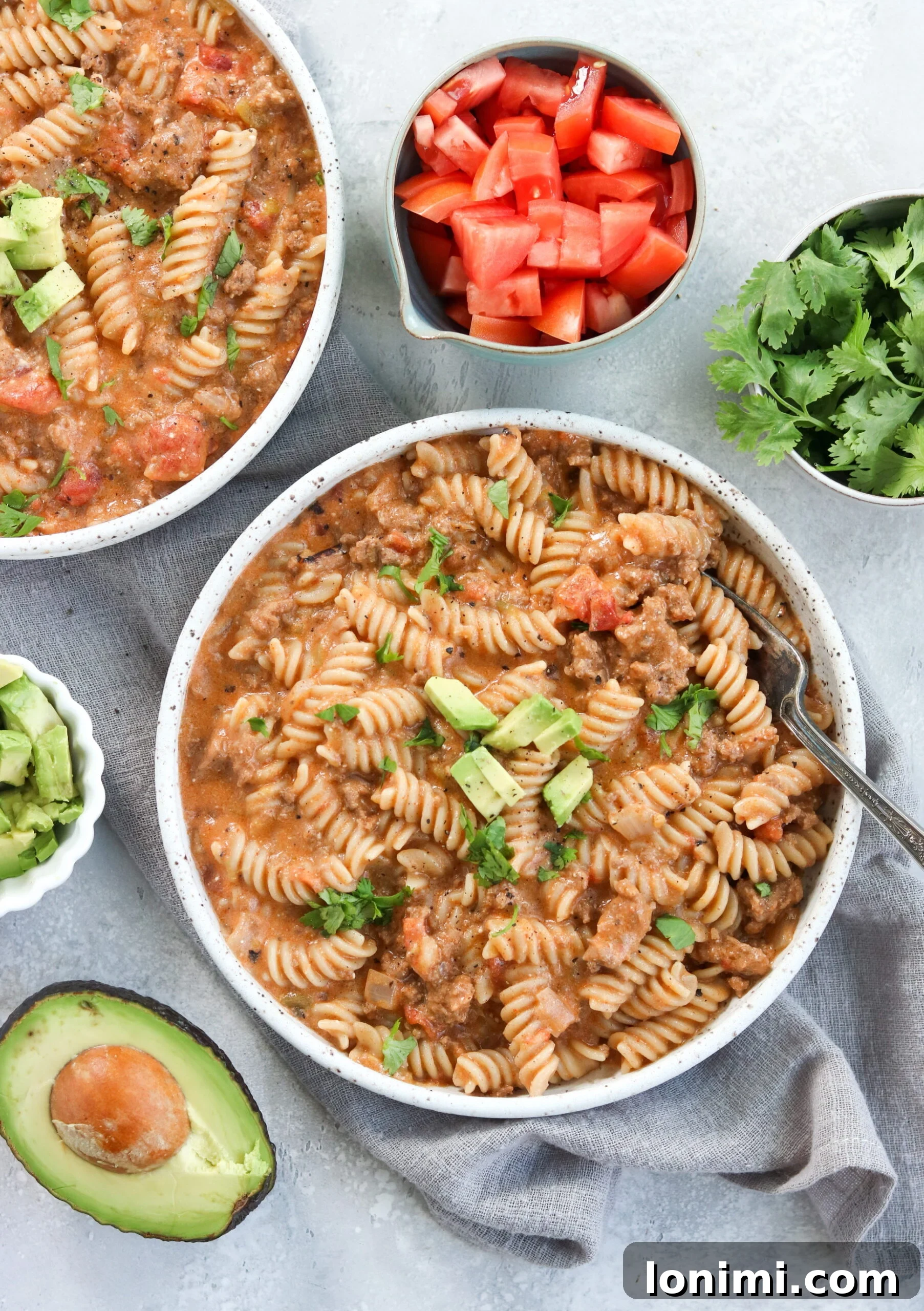 Top view of Instant Pot Taco Pasta with fresh cilantro and lime wedges
