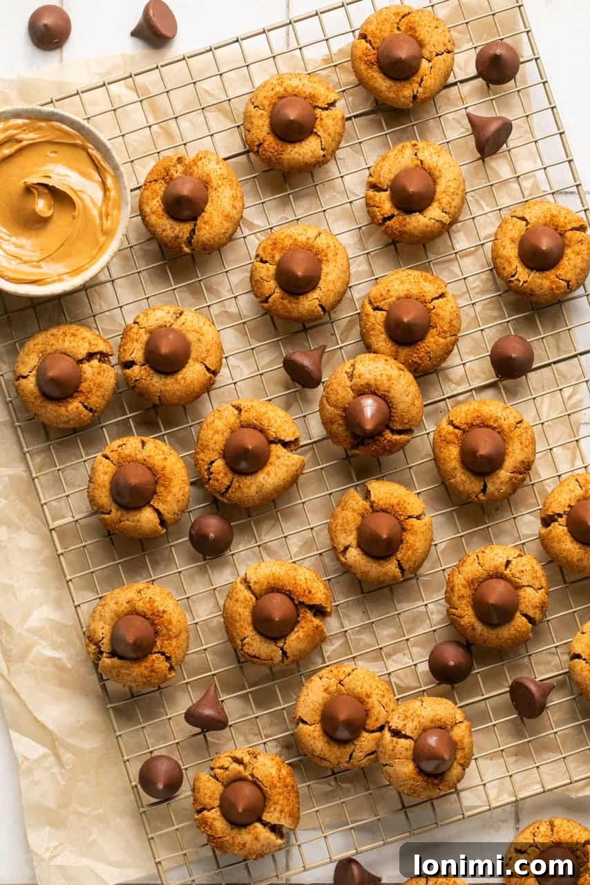 Foolproof Gluten Free Peanut Butter Blossoms 6 peanut butter cookies with Hershey Kisses on a cooling rack