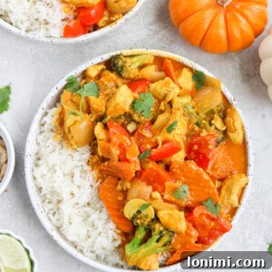 Paleo Pumpkin Curry in a white bowl, garnished with fresh cilantro.