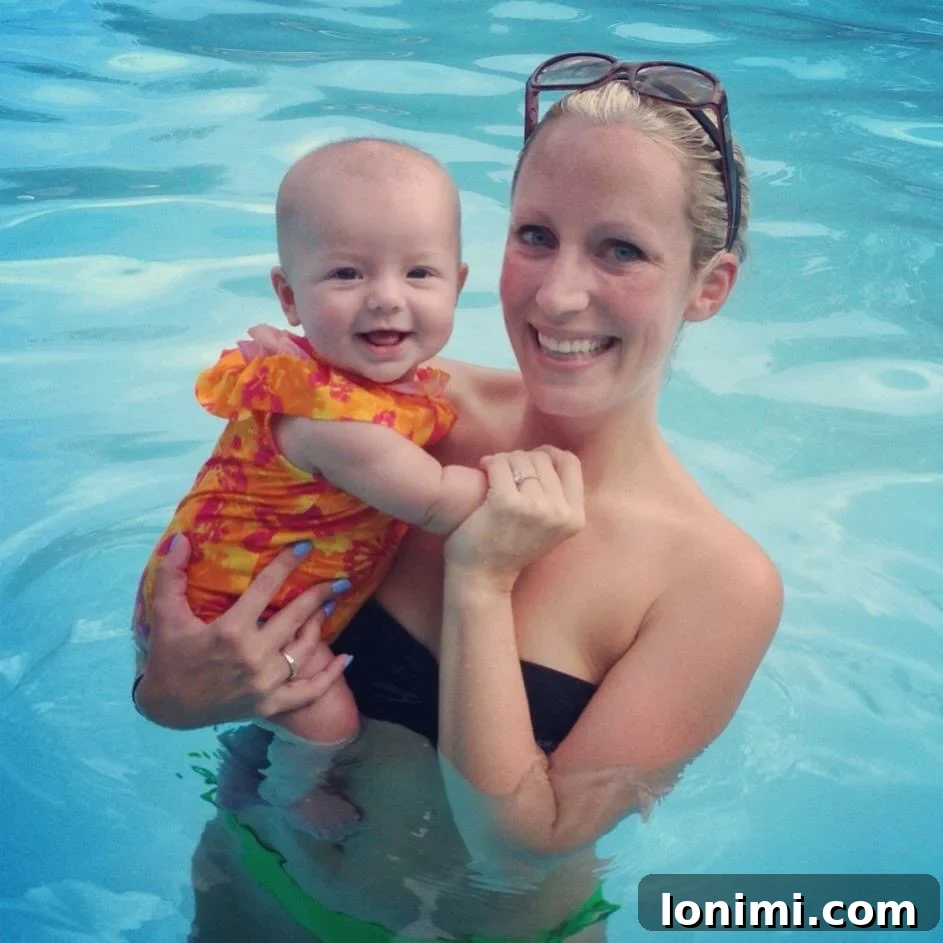 A young mother smiling with her baby in her arms, looking happy, but hiding internal struggles.