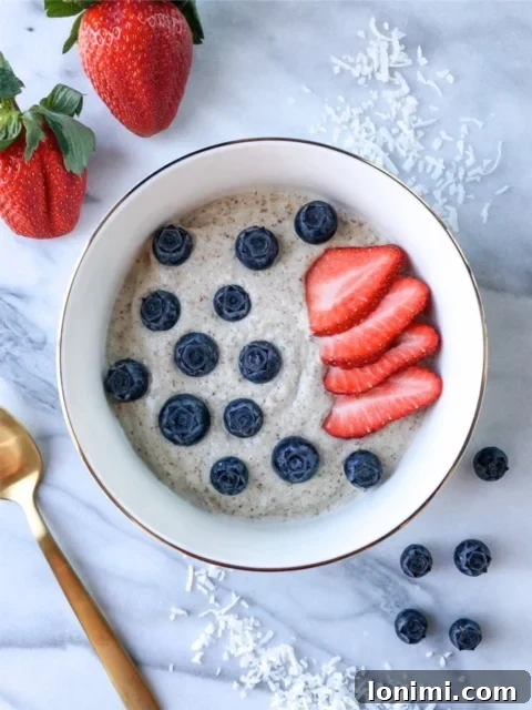 A comforting bowl of Macadamia N'oatmeal topped with fresh fruit.