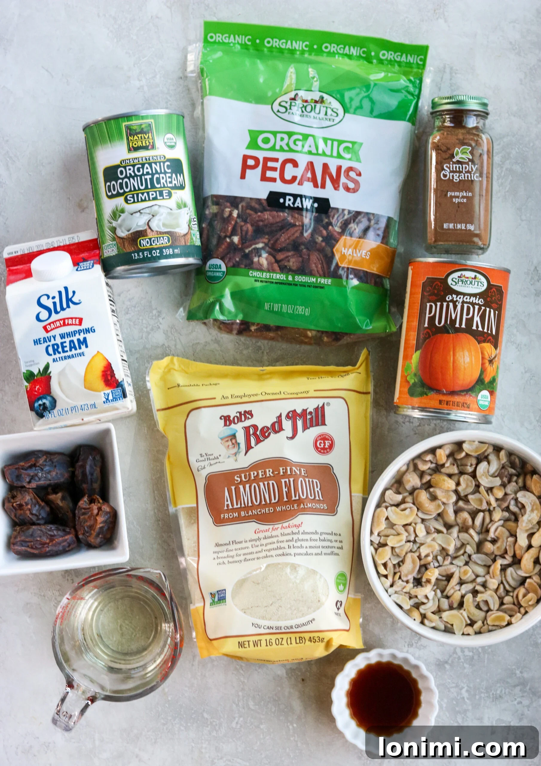 all the ingredients to make the bars: coconut cream, dairy free whipping cream, pitted dates, almond flour, cashews, canned pumpkin, raw pecans, pumpkin pie spice, coconut oil, and vanilla extract.