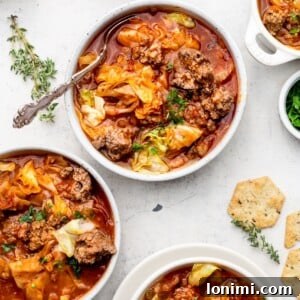 Three bowls of unstuffed cabbage soup with crackers