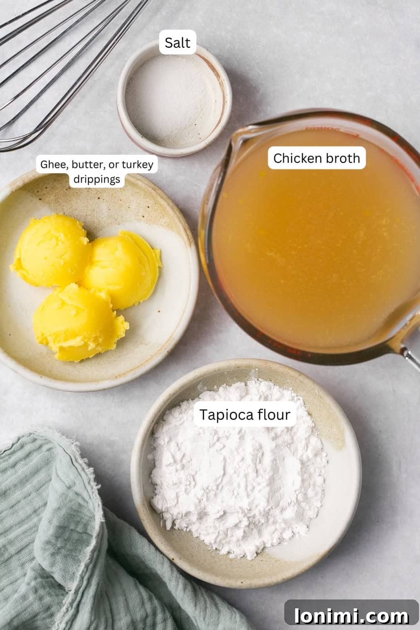 An array of simple, high-quality ingredients laid out on a clean surface, including a container of ghee or vegan butter, tapioca flour, and a carton of rich chicken broth, essential for making delicious gluten-free gravy.