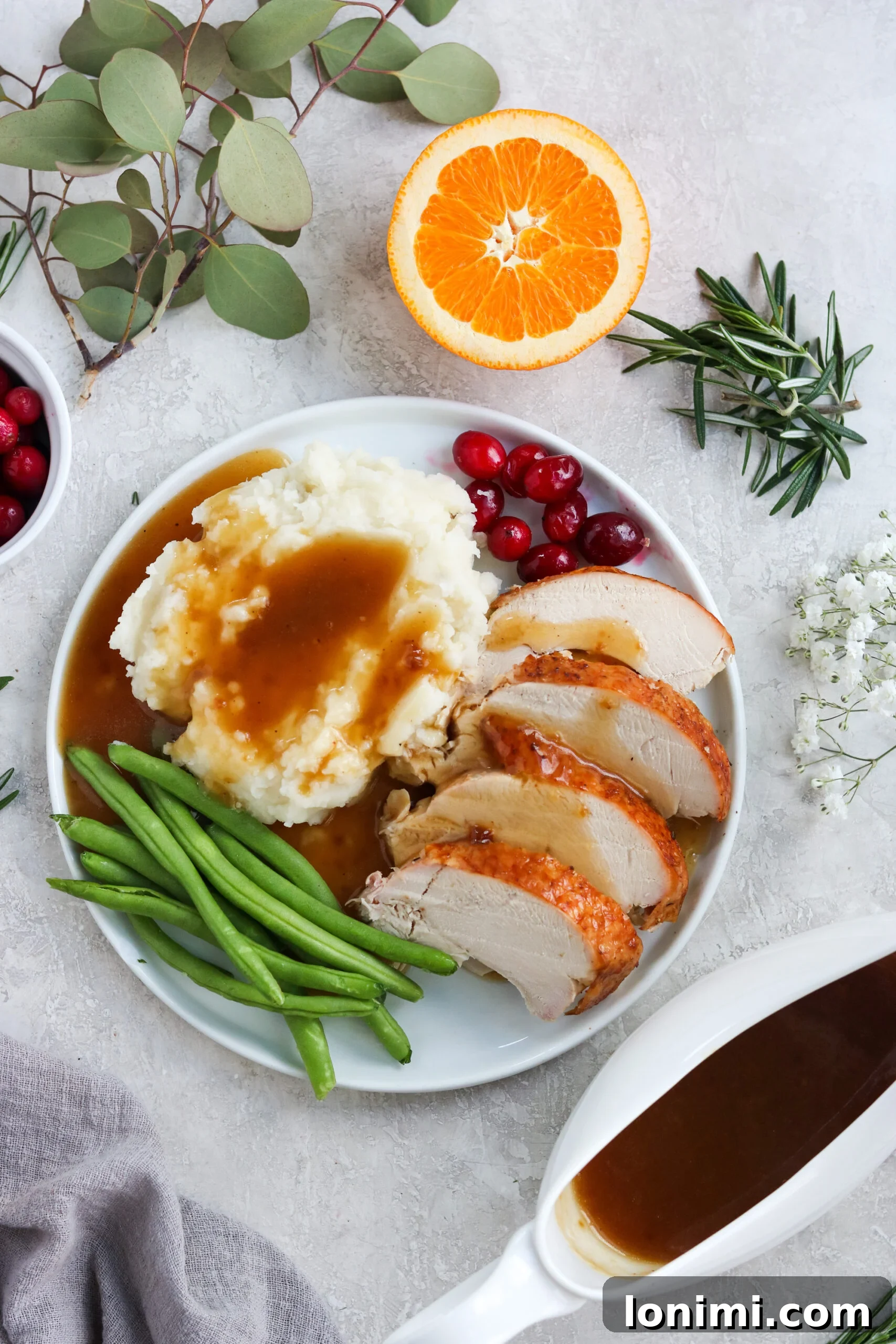 A vibrant holiday spread featuring golden-brown roasted turkey slices alongside a mound of creamy mashed potatoes, both generously drenched in rich, homemade gluten-free gravy, promising a comforting and flavorful experience.