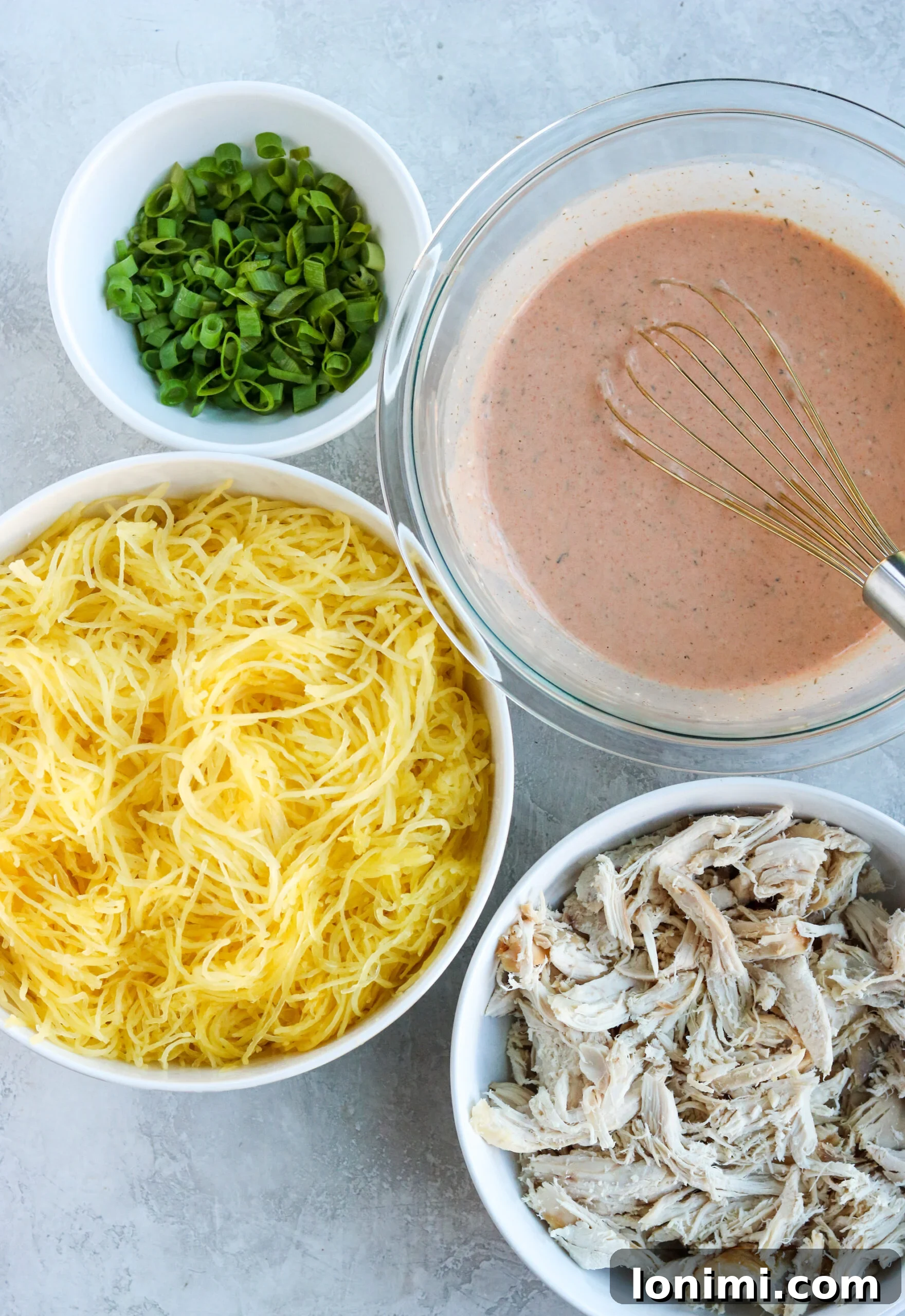 Guilt-Free Buffalo Chicken Spaghetti Squash Bake 3 A collection of fresh, wholesome ingredients laid out on a clean surface, ready for preparing the Buffalo Chicken Spaghetti Squash Casserole, including spaghetti squash, shredded chicken, hot sauce, and dairy-free cream cheese.