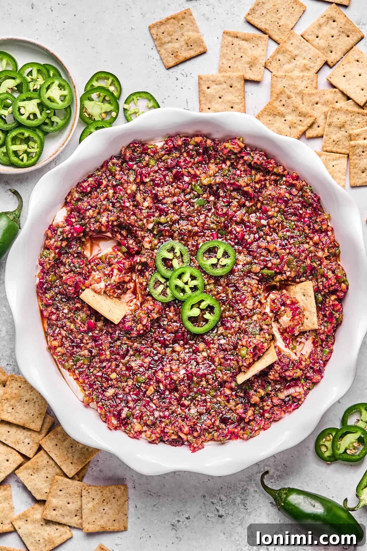 Dairy-Free Cranberry Jalapeno Dip: The Perfect Sweet Heat 12 cranberry jalapeno dip in a pie plate with crackers